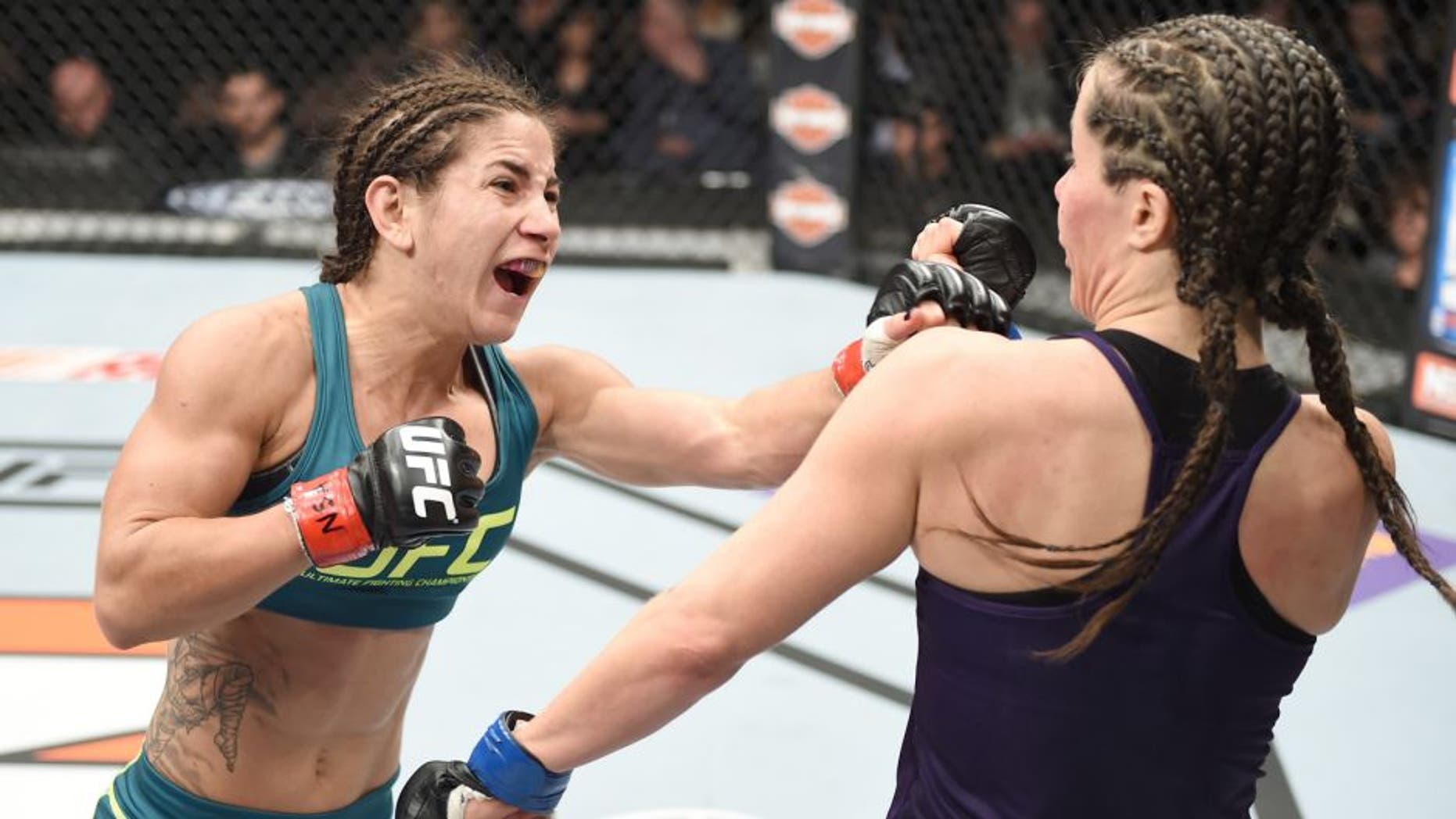 LAS VEGAS, NEVADA - DECEMBER 12: (L-R) Tecia Torres punches Angela Magana in their strawweight fight during The Ultimate Fighter Finale event inside the Pearl concert theater at the Palms Casino Resort on December 12, 2014 in Las Vegas, Nevada. (Photo by Jeff Bottari/Zuffa LLC/Zuffa LLC via Getty Images)