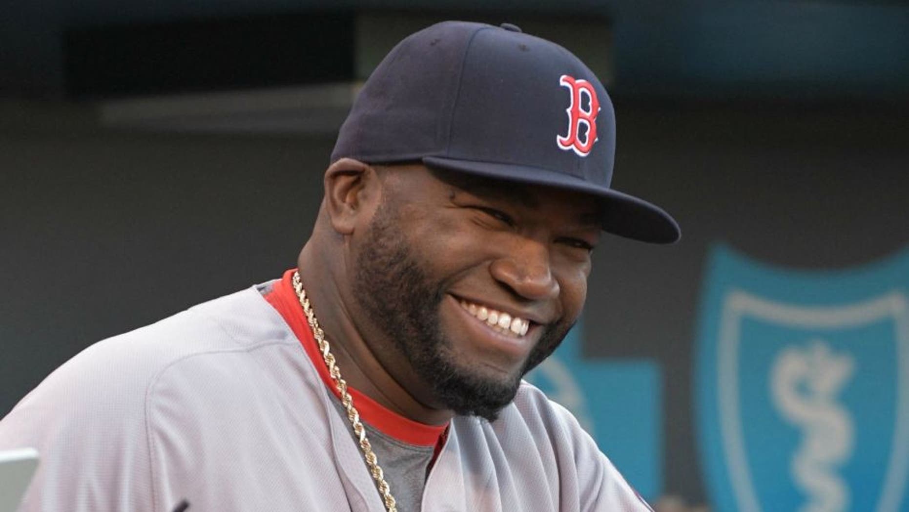 May 17, 2016; Kansas City, MO, USA; Boston Red Sox designated hitter David Ortiz (34) smiles before heading onto the field to be presented with a painting of himself in the World Series and a case of Kansas City barbecue sauces before the game against the Kansas City Royals at Kauffman Stadium. The Royals won 8-4. Mandatory Credit: Denny Medley-USA TODAY Sports