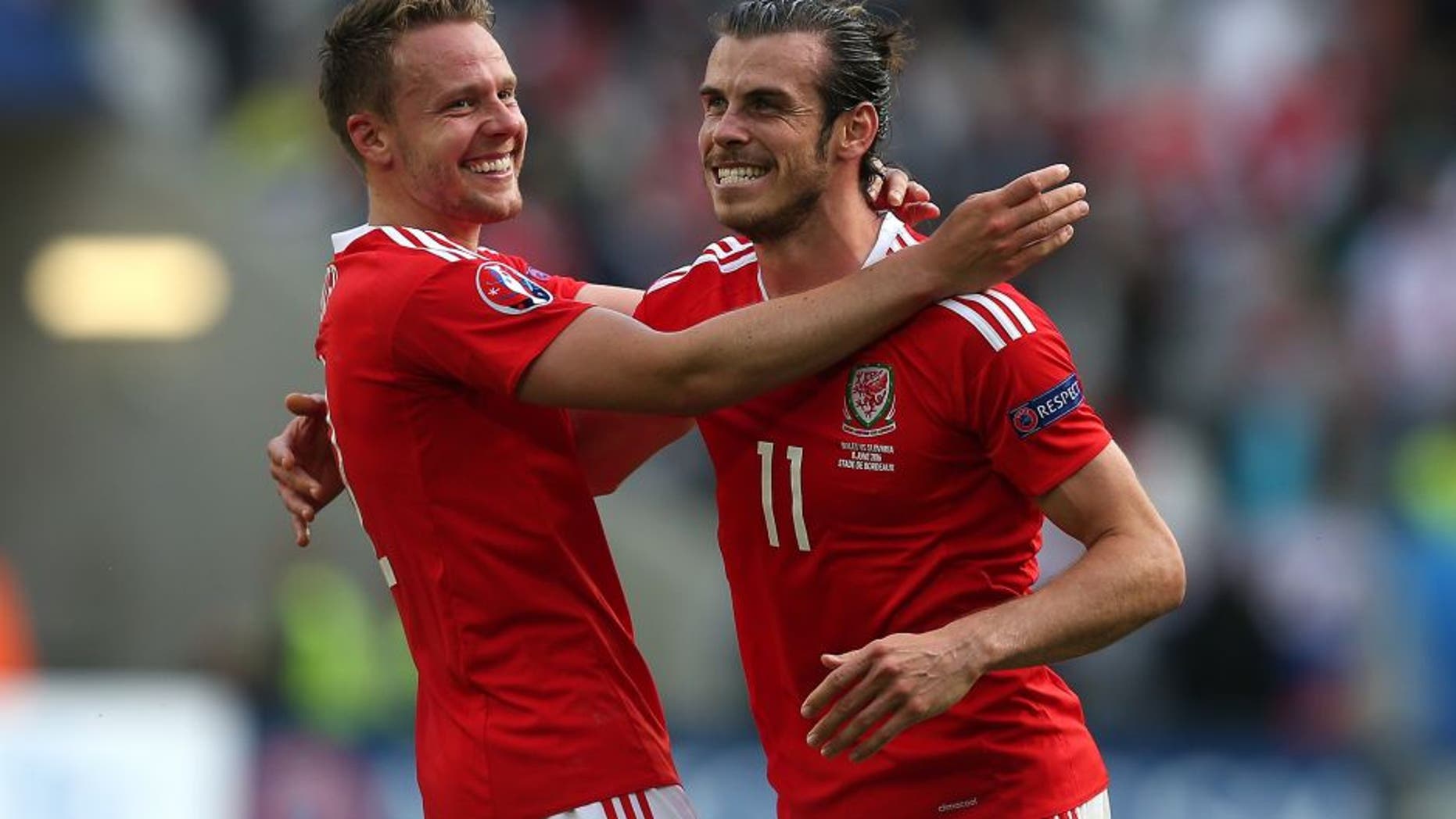 BORDEAUX, FRANCE - JUNE 11: Gareth Bale of Wales celebrates at full-time with team-mate Chris Gunther following the UEFA Euro 2016 Group B match between Wales and Slovakia at Nouveau Stade de Bordeaux on June 11, 2016 in Bordeaux, France. (Photo by Chris Brunskill Ltd/Getty Images)