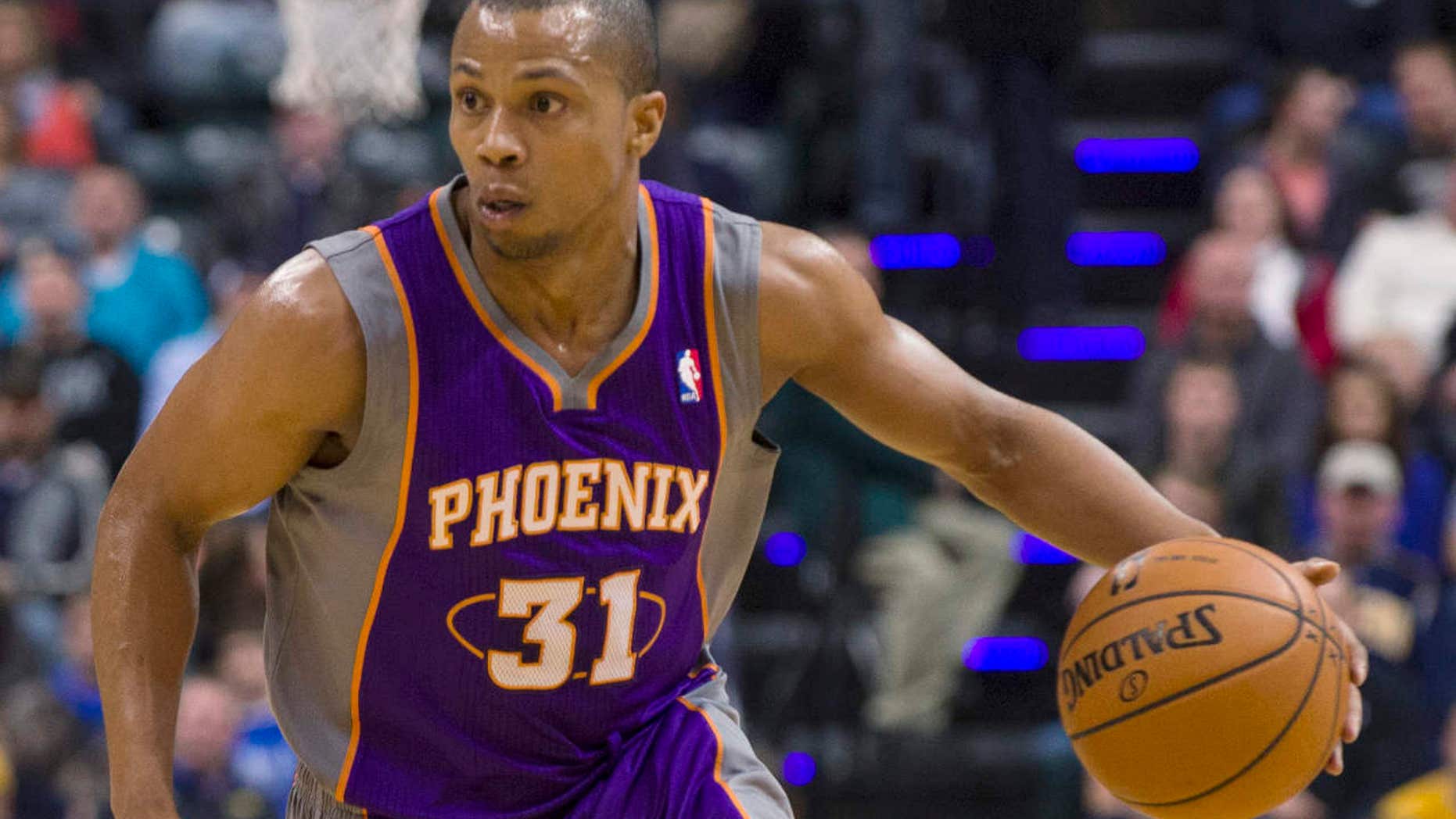 FILE - In this Dec. 28, 2012, file photo, Phoenix Suns' Sebastian Telfair brings the ball up against Indiana Pacers' Tyler Hansbrough during a basketball game in Indianapolis.
