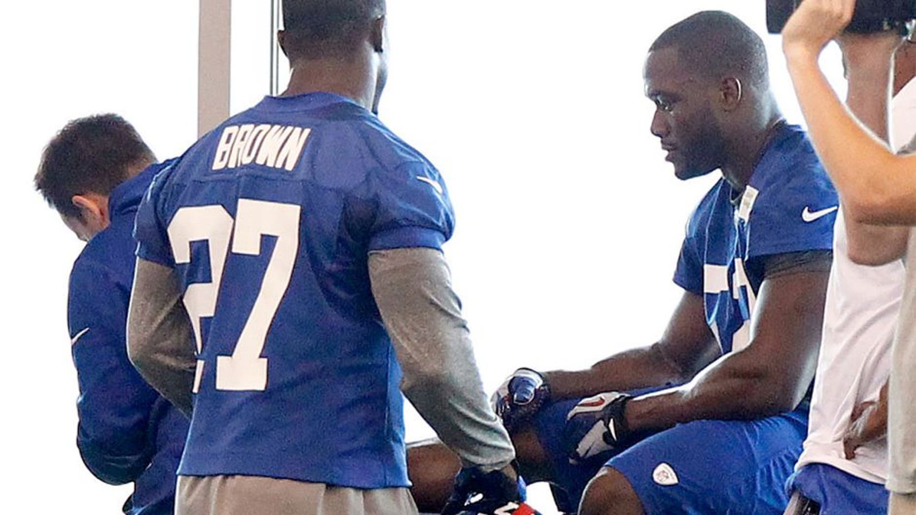 Jun 12, 2014; East Rutherford, NJ, USA; New York Giants outside linebacker Jon Beason (52) is tended to on the sidelines during New York Giants minicamp at the Quest Diagnostics Training Center. William Perlman/The Star-Ledger-USA TODAY Sports
