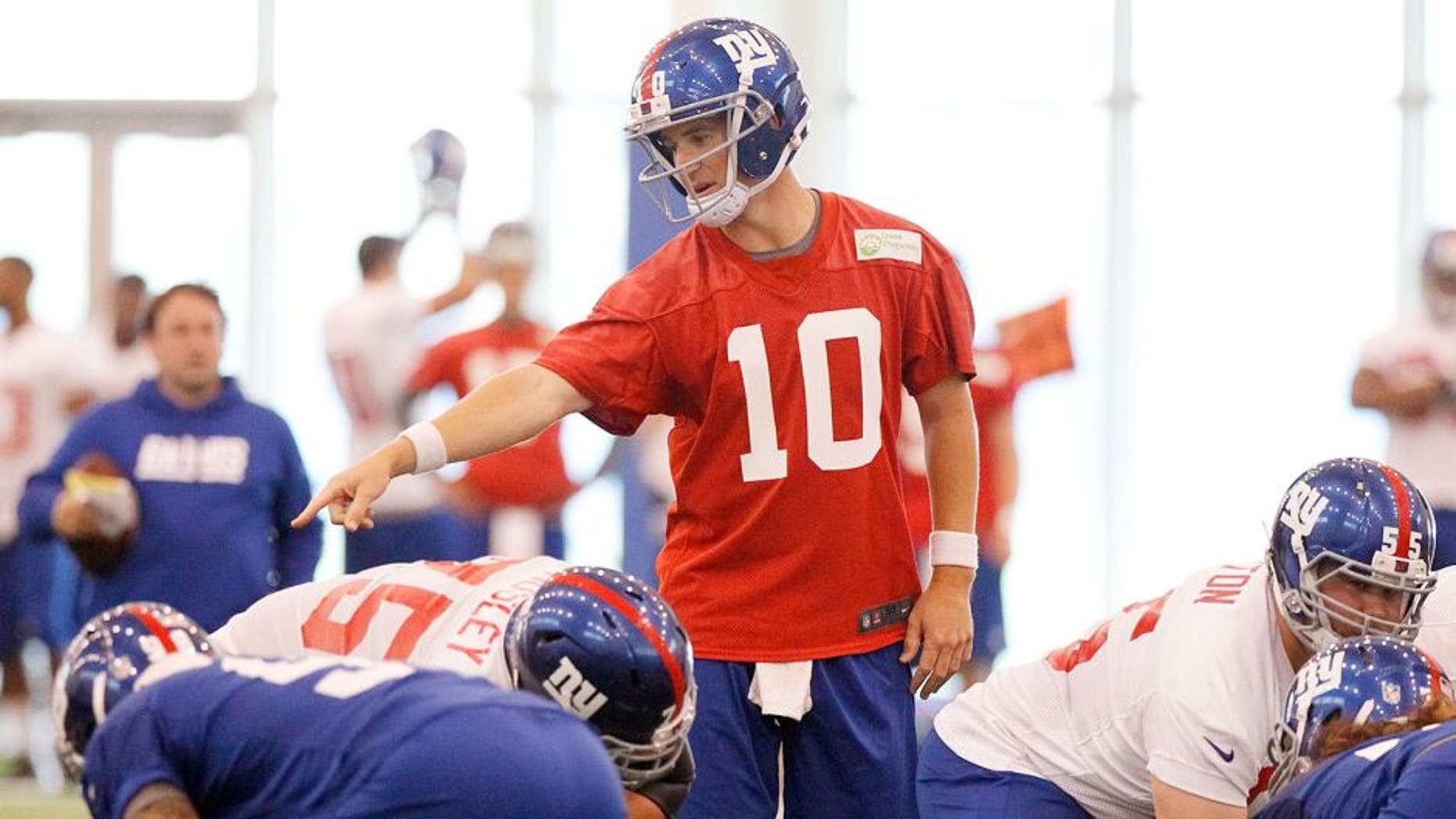 Jun 12, 2014; East Rutherford, NJ, USA; New York Giants quarterback Eli Manning (10) calls a play during New York Giants minicamp at the Quest Diagnostics Training Center. William Perlman/The Star-Ledger-USA TODAY Sports