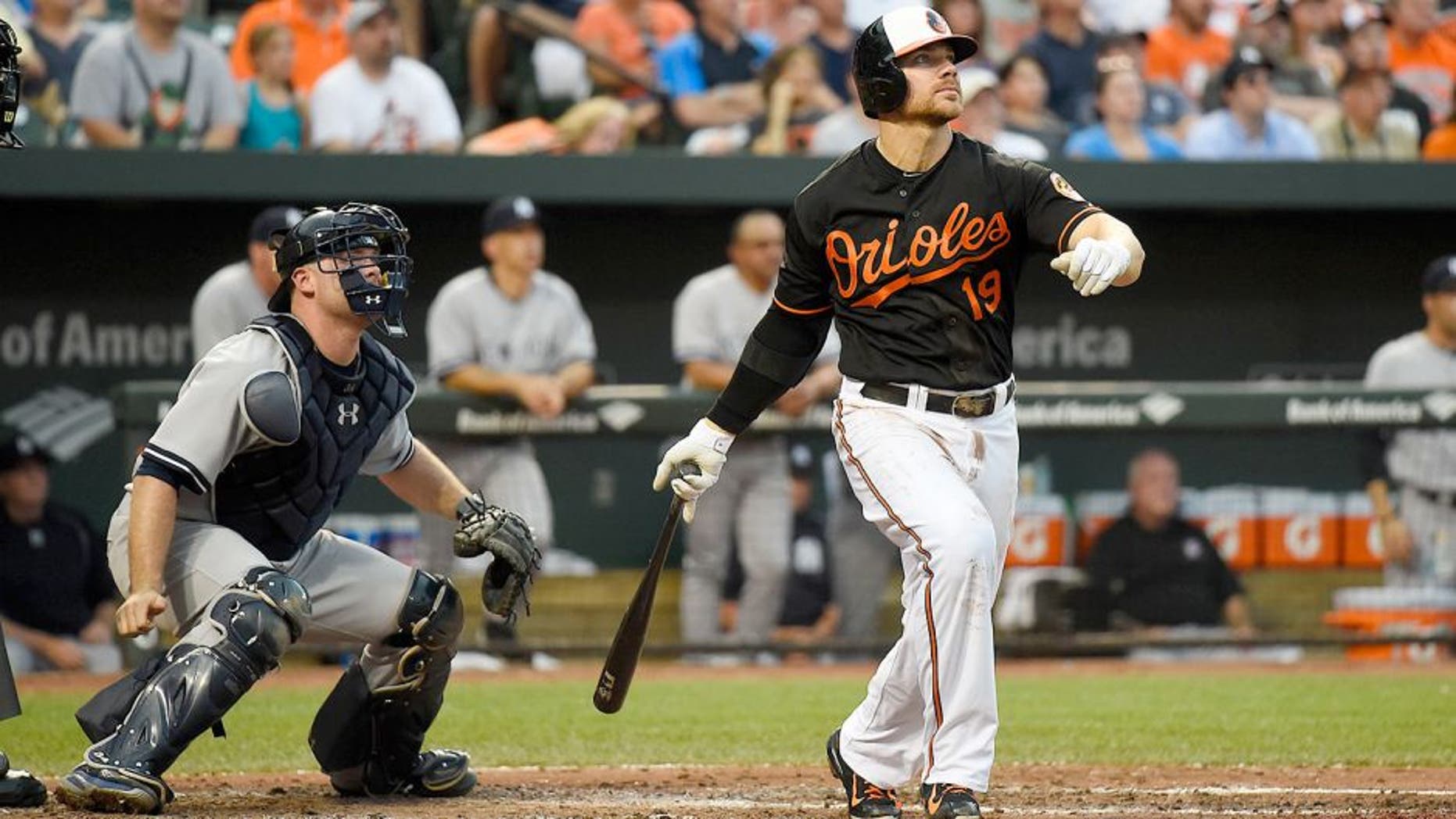 Jun 12, 2015; Baltimore, MD, USA; Baltimore Orioles first baseman Chris Davis (19) hits a three run home run during the third inning against the New York Yankees at Oriole Park at Camden Yards. Mandatory Credit: Tommy Gilligan-USA TODAY Sports