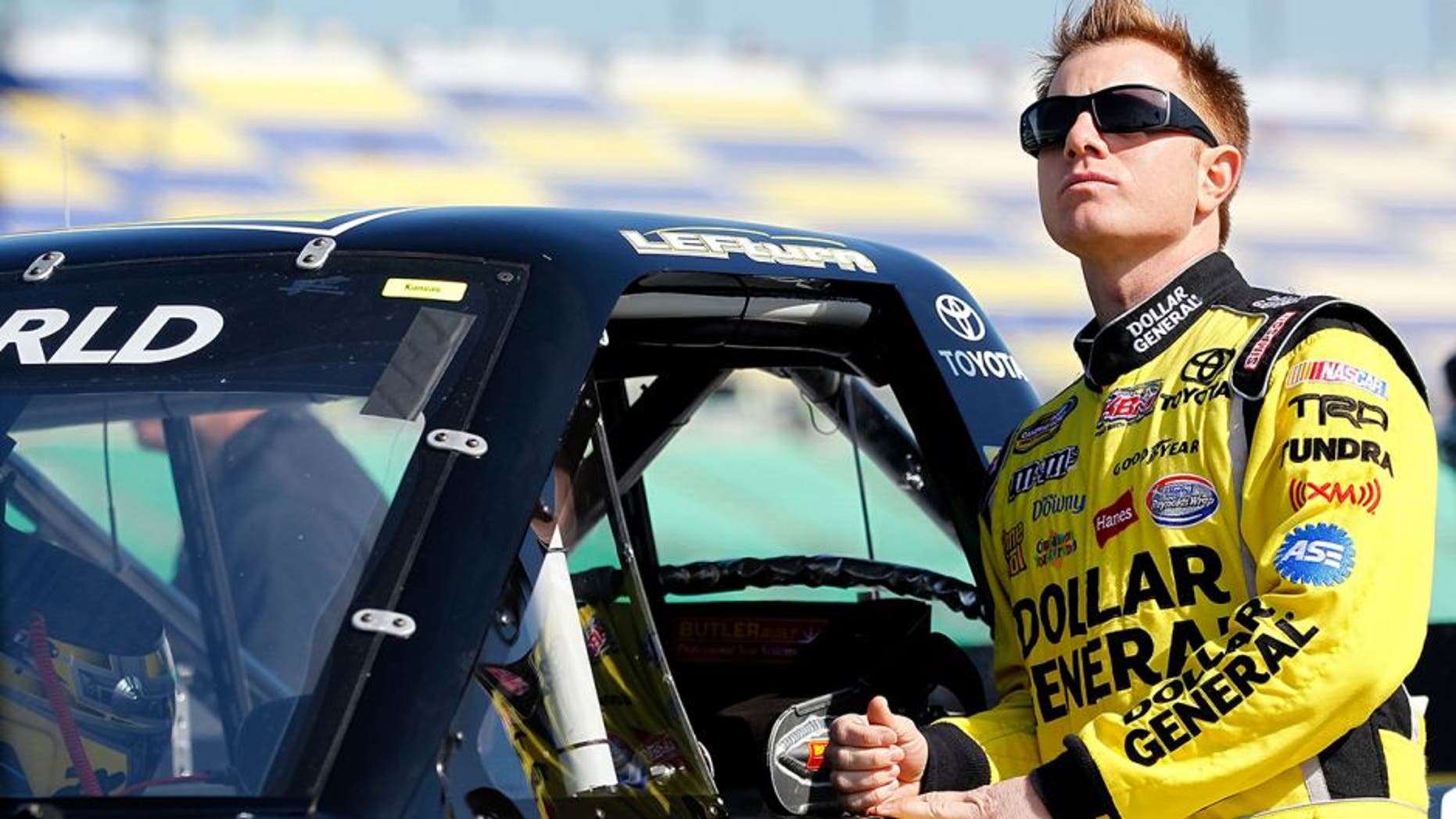 KANSAS CITY, KS - APRIL 21: Jason Leffler, driver of the #18 Shore Lodge Toyota, looks on during qualifying for NASCAR Camping World Truck Series SFP 250 at Kansas Speedway on April 21, 2012 in Kansas City, Kansas. (Photo by Geoff Burke/Getty Images for NASCAR)