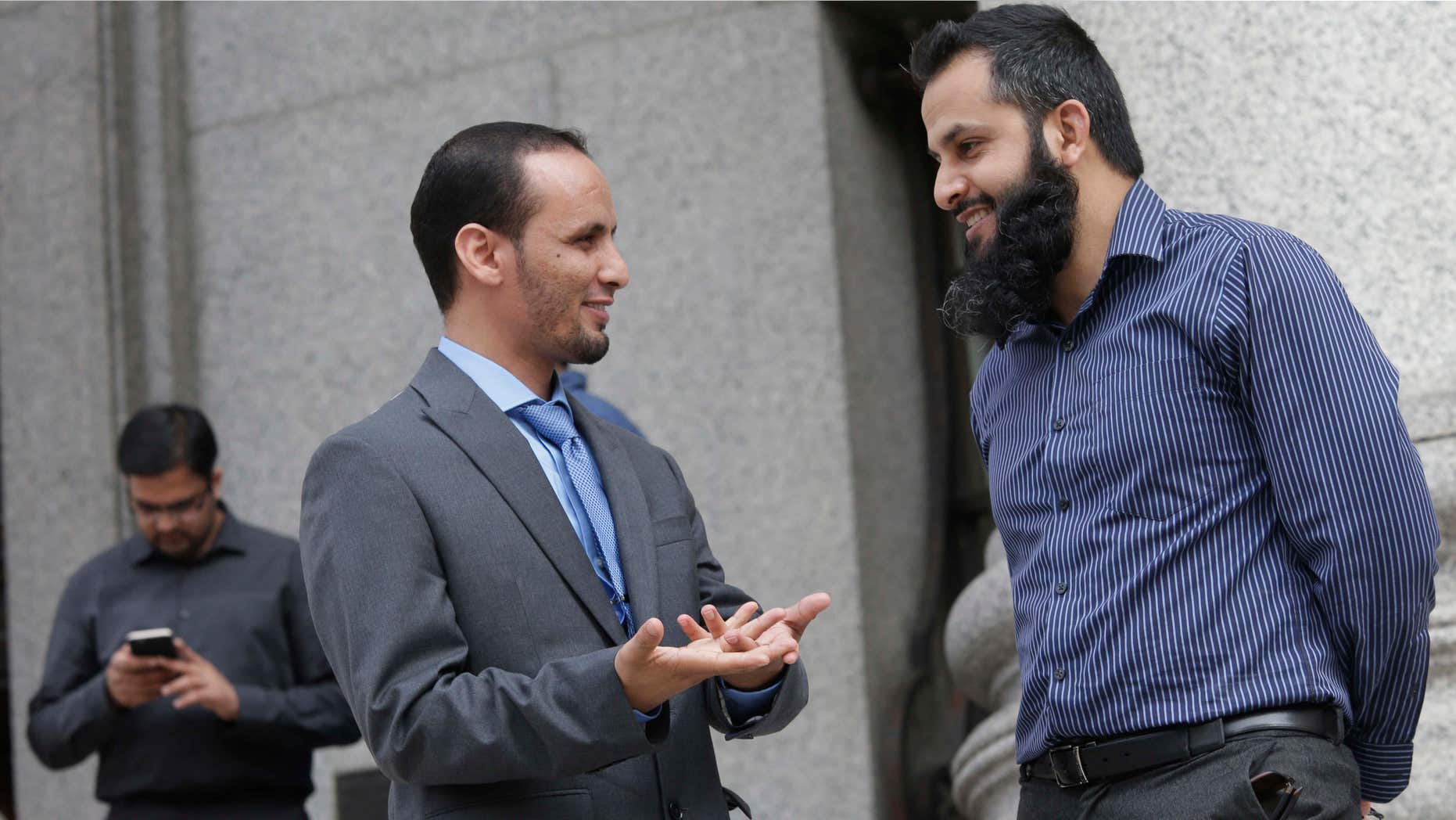 June 12, 2015: Naveed Shinwari, right, Jameel Algibhah, center, and Awais Sajjad talk as they leave the federal courthouse in the Manhattan borough of New York.