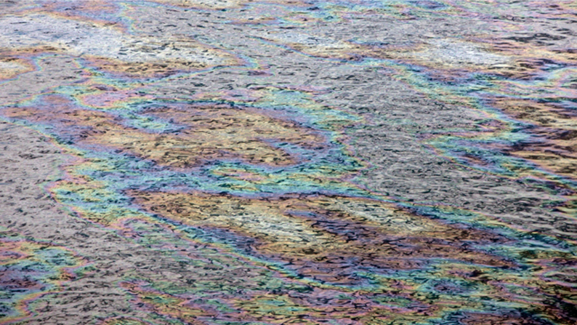 June 13: The surface of the Gulf of Mexico glistens with color as light reflects off the oil sheen at the site of the Deepwater Horizon oil spill in the Gulf of Mexico.