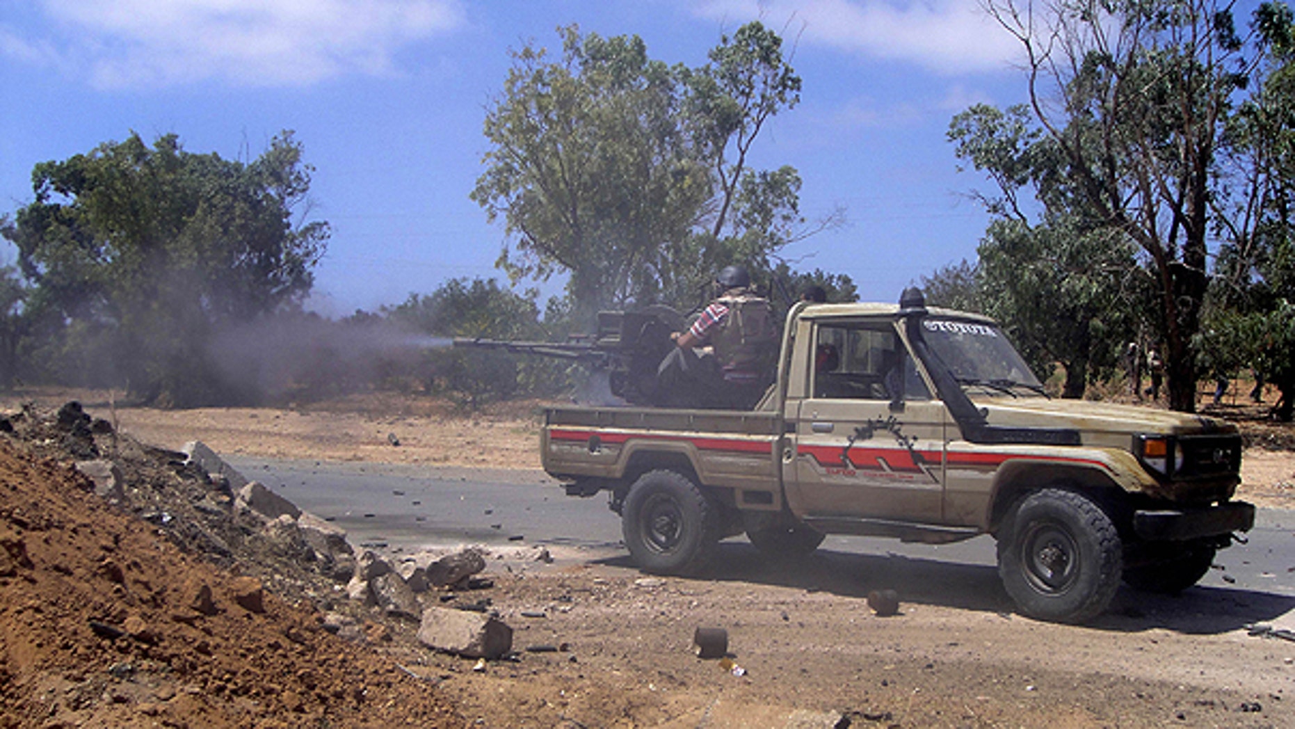 June 12: Rebel fighters fire their machine guns towards Muammar Qaddafi orces at the frontline of Dafniya, west Misrata, Libya.