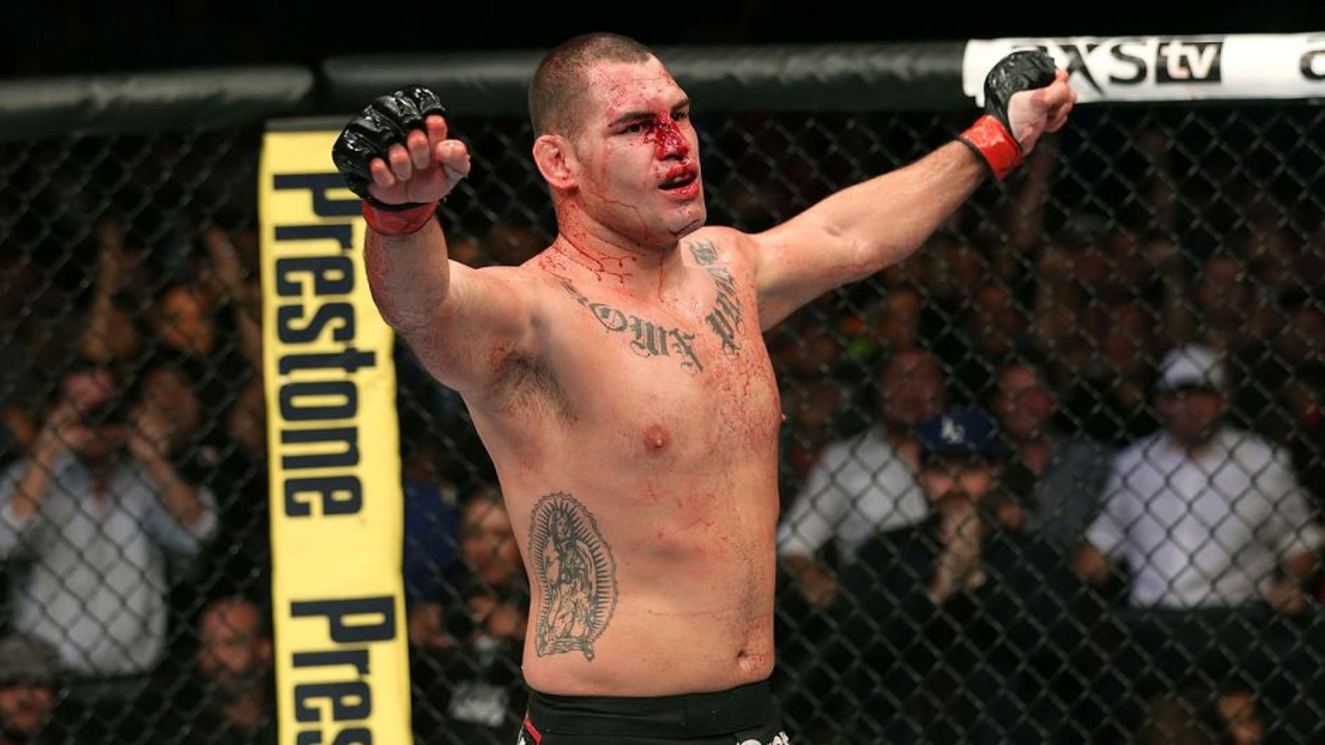 HOUSTON, TEXAS - OCTOBER 19: Cain Velasquez celebrates after defeating Junior Dos Santos (not pictured) by TKO in their UFC heavyweight championship bout at the Toyota Center on October 19, 2013 in Houston, Texas. (Photo by Nick Laham/Zuffa LLC/Zuffa LLC via Getty Images)