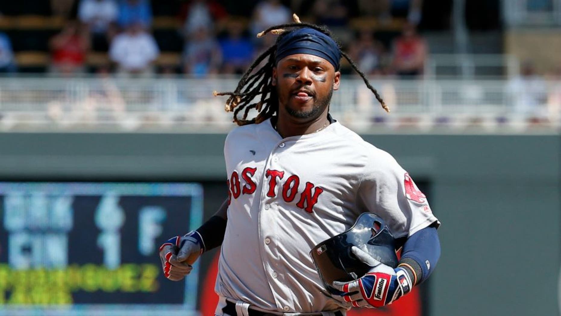 Boston Red Sox's Hanley Ramirez carries his batting helmet while running to third base on a throwing error by Minnesota Twins catcher Juan Centeno during the eighth inning of a baseball game in Minneapolis, Sunday, June 12, 2016. The Twins won 7-4. (AP Photo/Ann Heisenfelt)