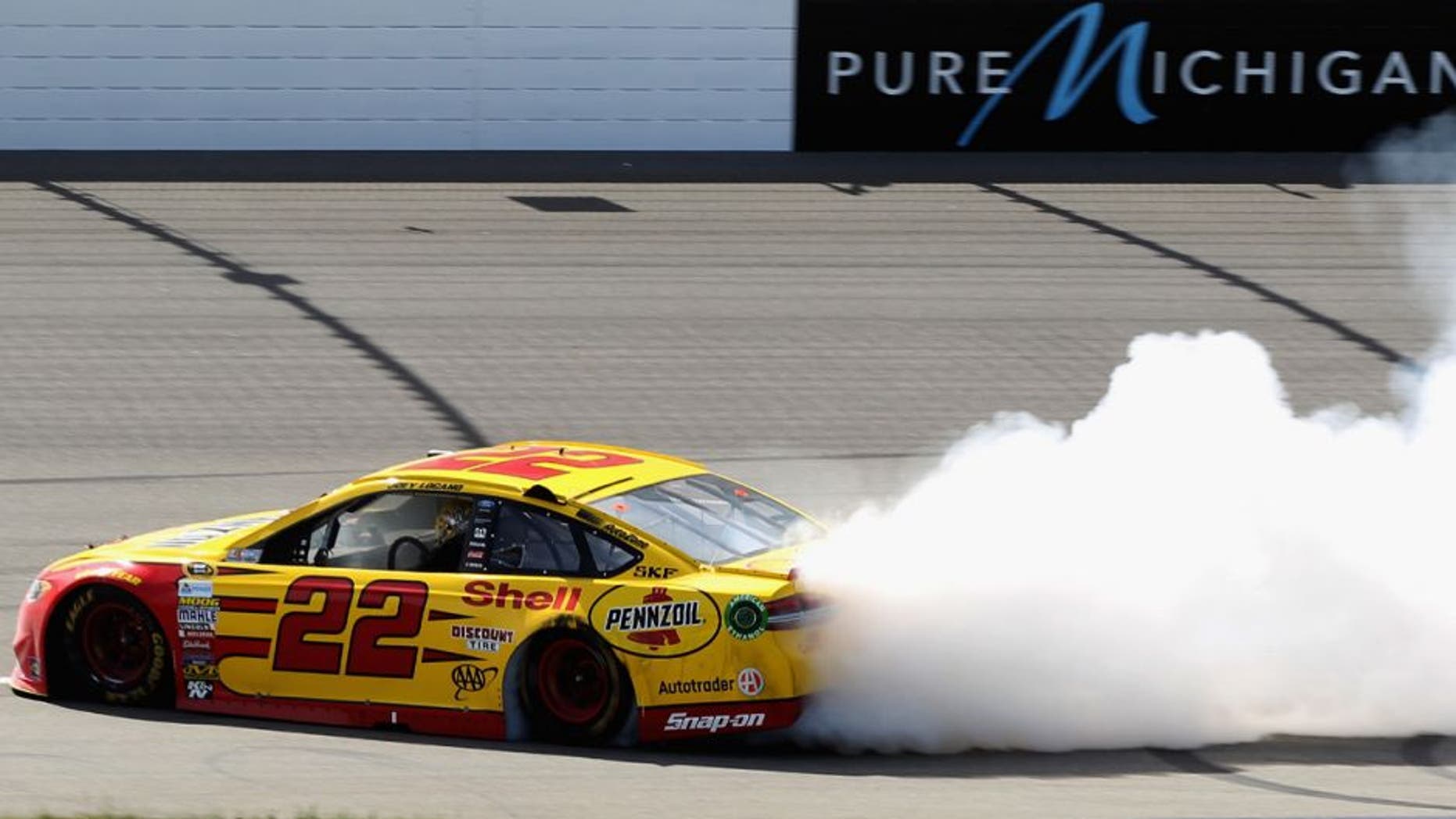BROOKLYN, MI - JUNE 12: Joey Logano, driver of the #22 Shell Pennzoil Ford, celebrates with a burnout after winning the NASCAR Sprint Cup Series FireKeepers Casino 400 at Michigan International Speedway on June 12, 2016 in Brooklyn, Michigan. (Photo by Kena Krutsinger/Getty Images )