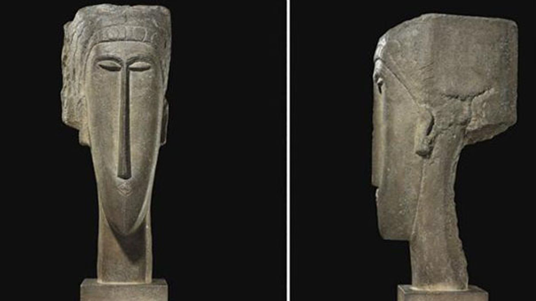The stone sculpture 'Tete' by artist Amedeo Modigliani has sold for a record $52.8 million at auction in Paris.