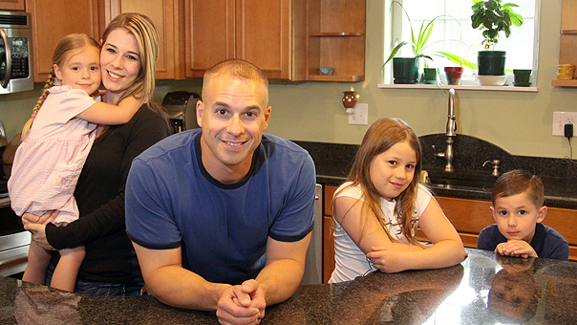 June 8: James Tritle with his wife Angela and their children BreAnna, Makayla and Cameron pose for a photo at their home in North Pole, Alaska.