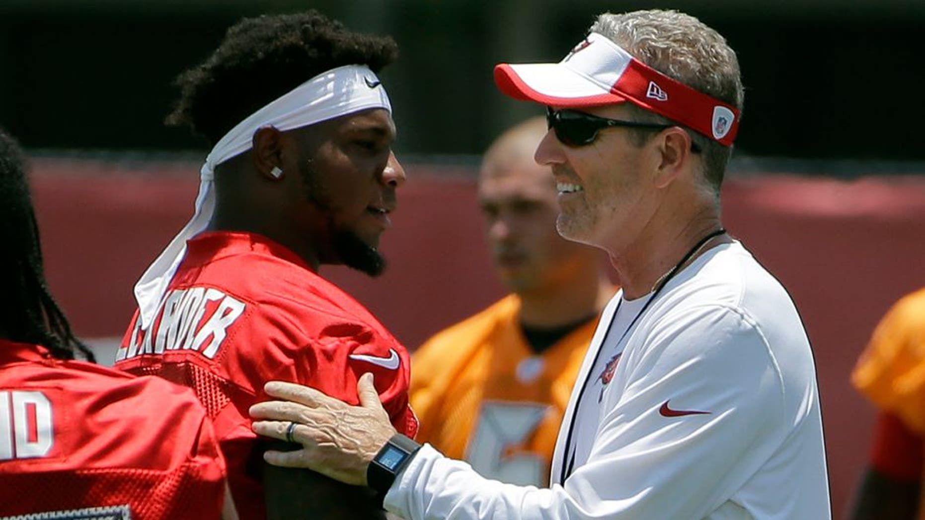 Tampa Bay Buccaneers head coach Dirk Koetter, right, greets middle linebacker Kwon Alexander (58) before drills at an NFL football minicamp Tuesday, June 14, 2016, in Tampa, Fla. (AP Photo/Chris O'Meara)
