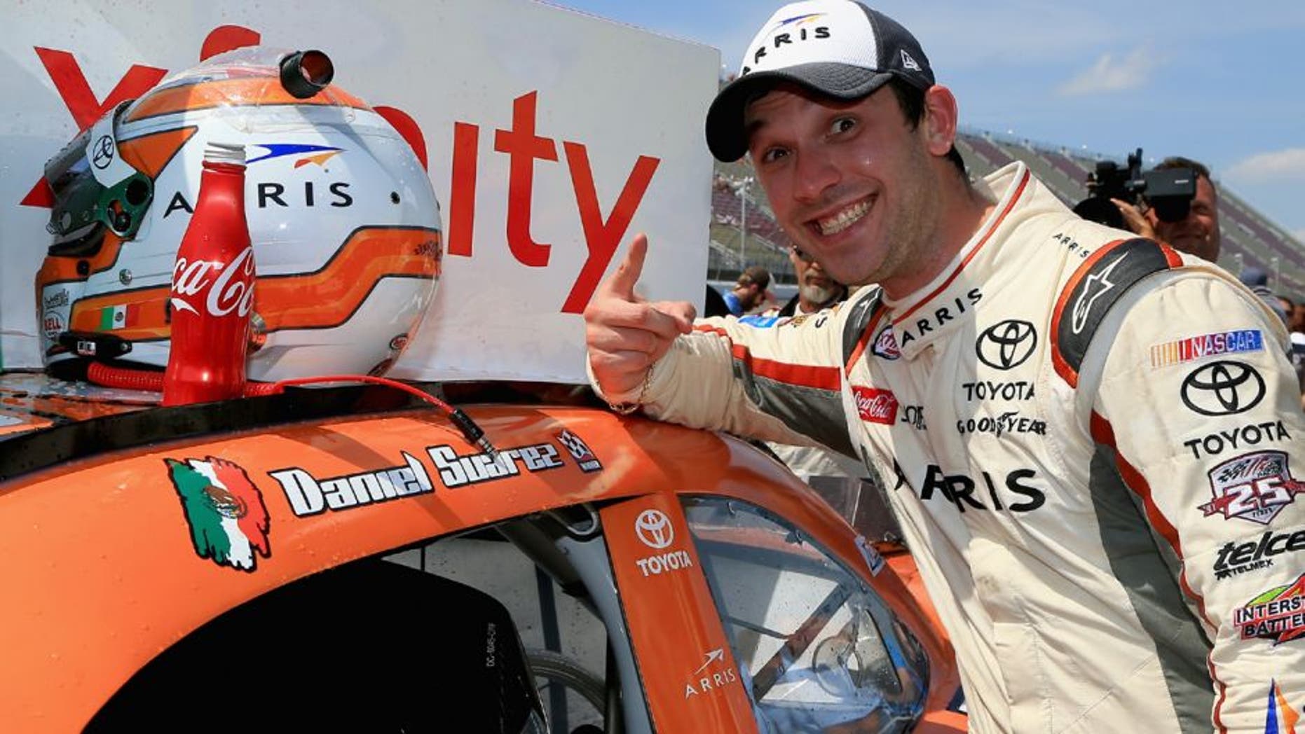 BROOKLYN, MI - JUNE 11: Daniel Suarez, driver of the #19 ARRIS Toyota, places a winner's sticker decal on his car after winning the NASCAR XFINITY Series Menards 250 at Michigan International Speedway on June 11, 2016 in Brooklyn, Michigan. (Photo by Daniel Shirey/NASCAR via Getty Images)