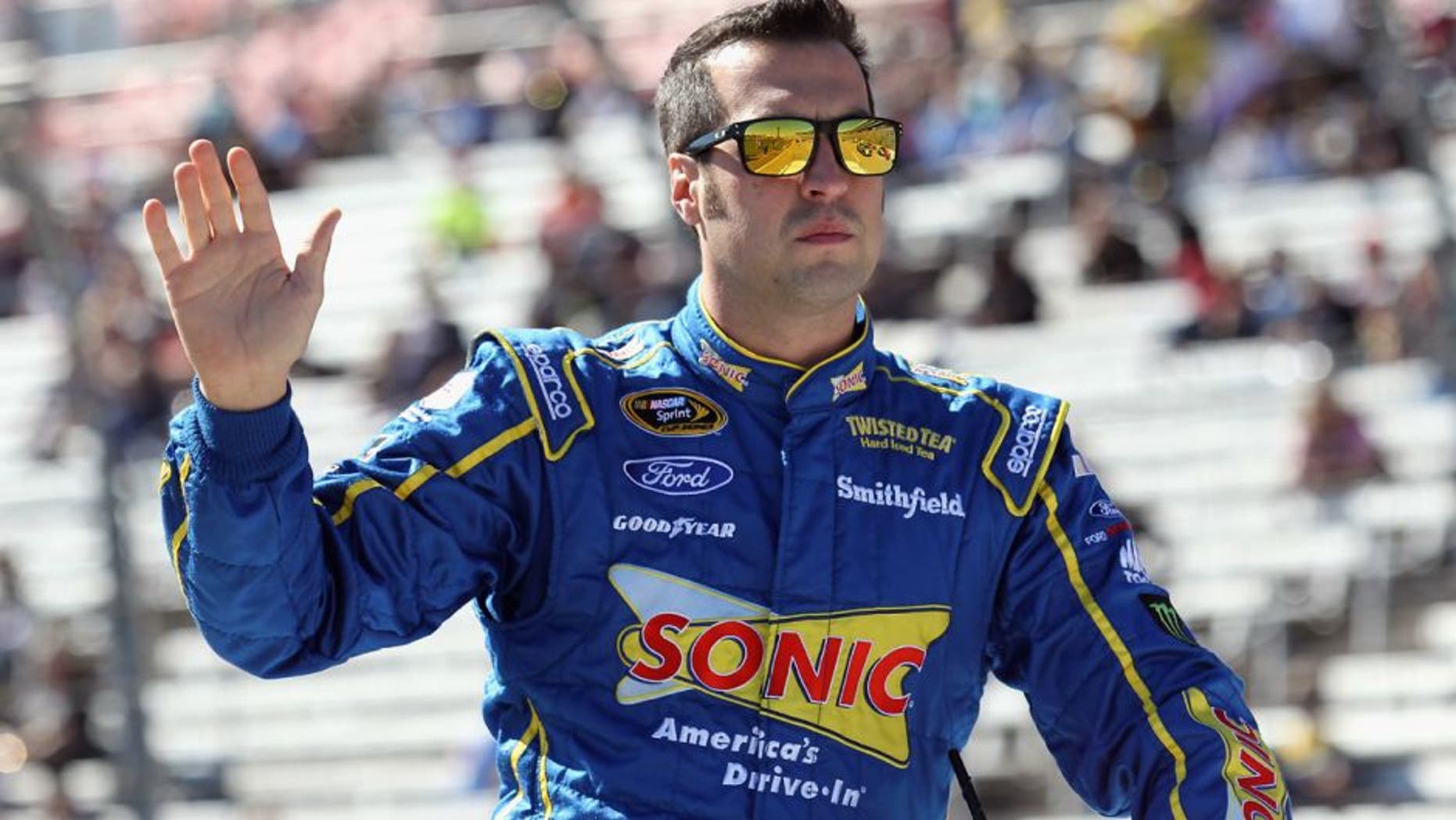 FORT WORTH, TX - NOVEMBER 08: Sam Hornish Jr., driver of the #9 Sonic Ford, greets fans from a parade vehicle during pre-race ceremonies for the NASCAR Sprint Cup Series AAA Texas 500 at Texas Motor Speedway on November 8, 2015 in Fort Worth, Texas. (Photo by Tim Bradbury/Getty Images for Texas Motor Speedway)