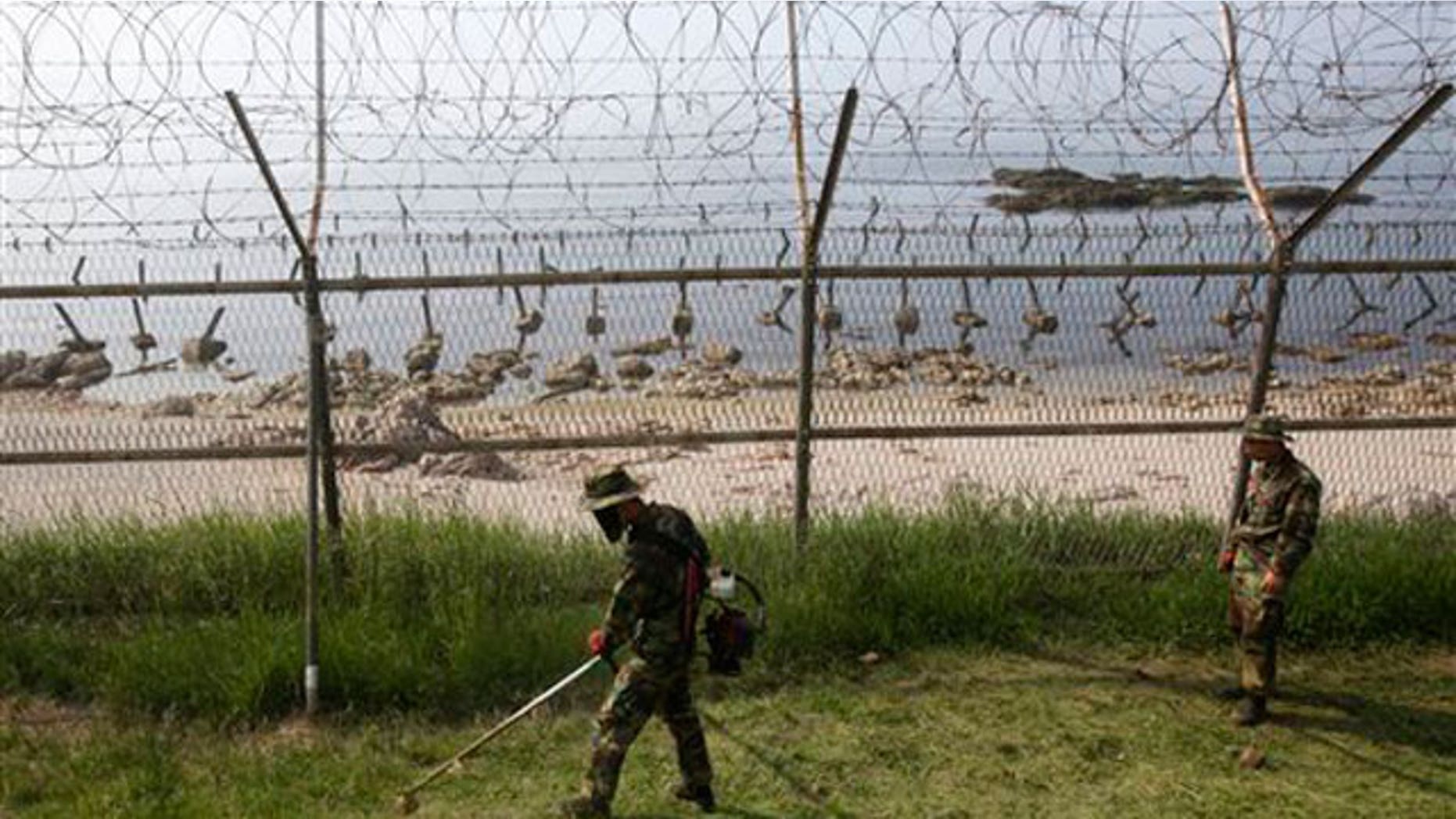 June 15: South Korean Marines work along the fence on Baengnyeong Island, South Korea, near the border with North Korea.