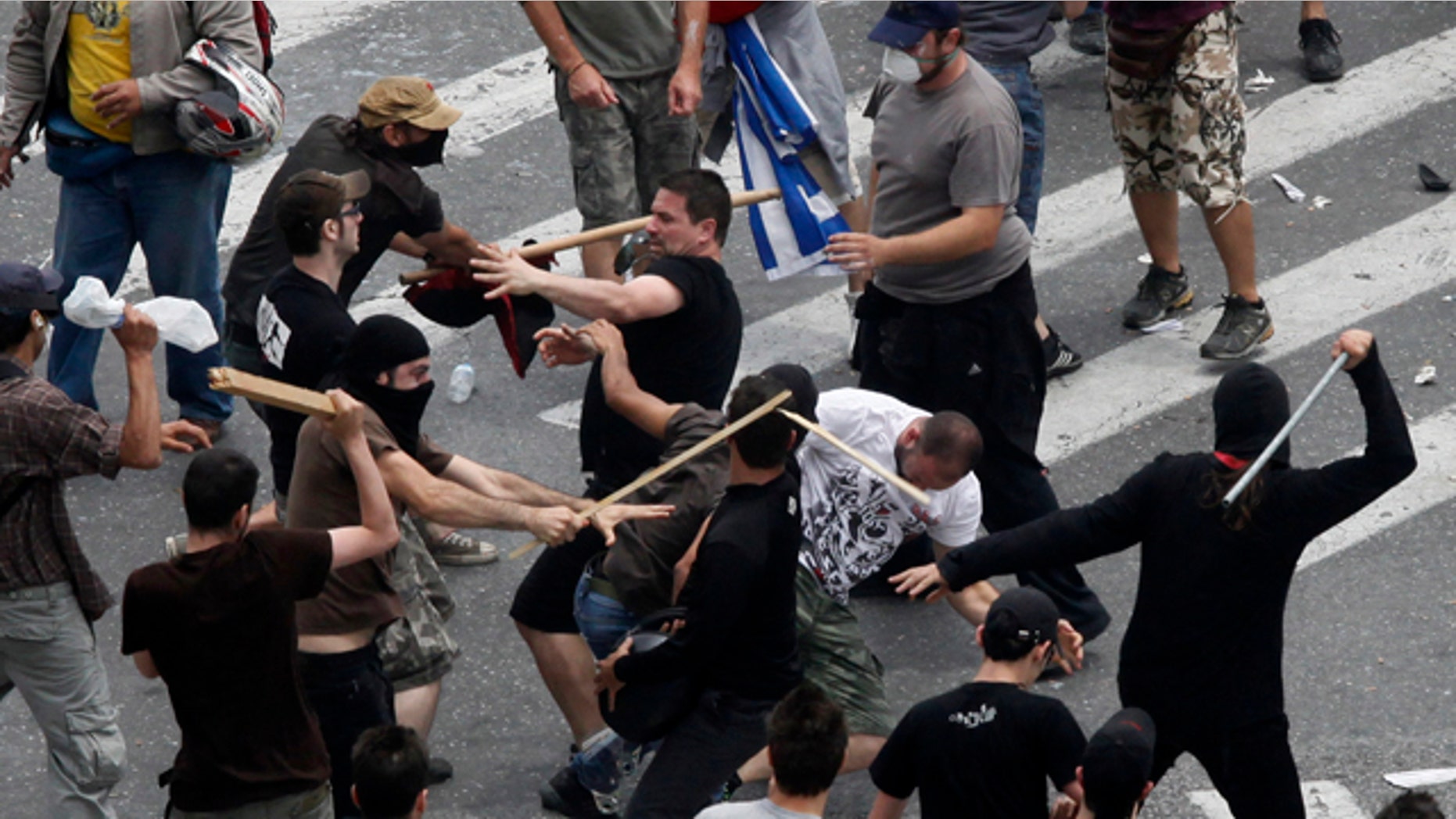 June 15: Left and right wing demonstrators fight at Syntagma square in front of the Greek Parliament in central Athens, during a rally against the new austerity measures.