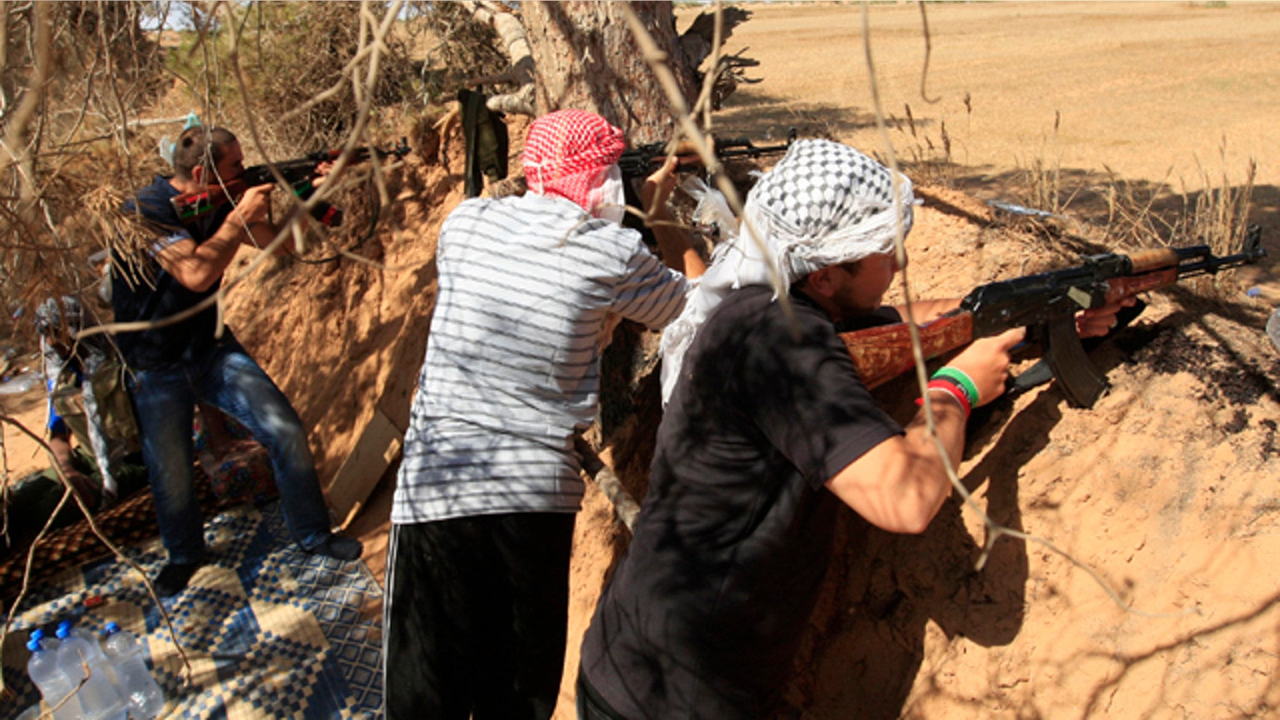 June 15: Rebel fighters fire towards pro-Muammar al-Qaddafi forces at the front line of Dafniya, about 25 miles west of Misrata, Libya.