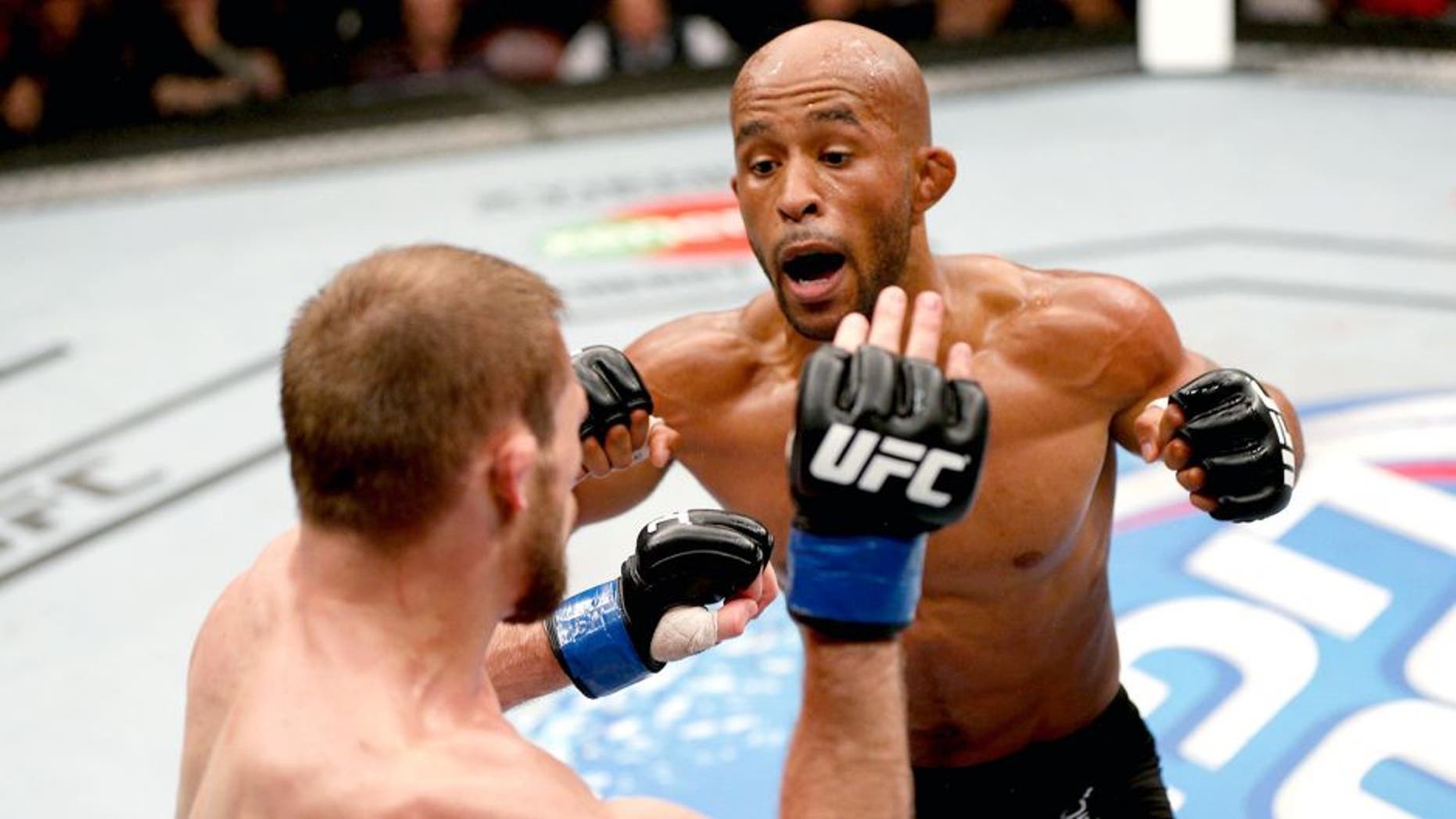 VANCOUVER, BC - JUNE 14: (R-L) Demtrious 'Mighty Mouse' Johnson punches Ali Bagautinov in their UFC flyweight championship bout at Rogers Arena on June 14, 2014 in Vancouver, Canada. (Photo by Josh Hedges/Zuffa LLC/Zuffa LLC via Getty Images)