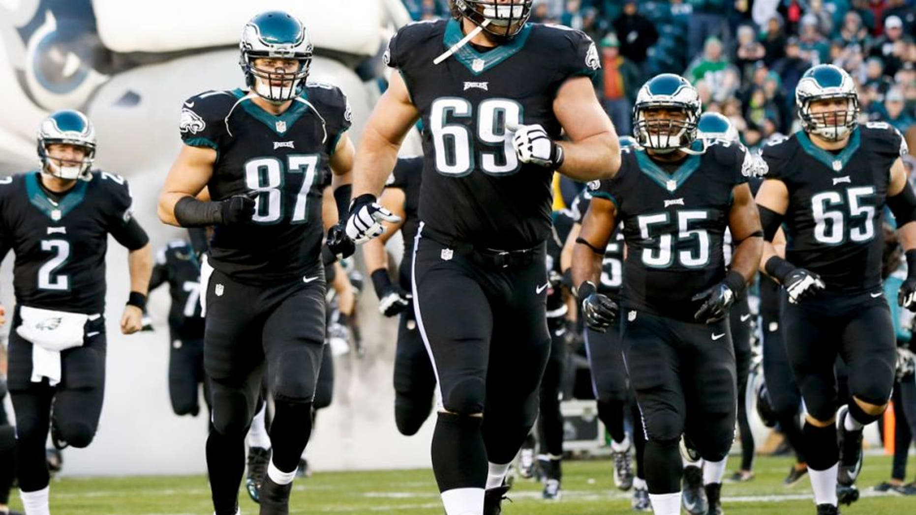 Dec 7, 2014; Philadelphia, PA, USA; Philadelphia Eagles guard Evan Mathis (69) and tight end Brent Celek (87) run out of the tunnel to begin a game against the Seattle Seahawks at Lincoln Financial Field. The Seahawks defeated the Eagles 24-14. Mandatory Credit: Bill Streicher-USA TODAY Sports