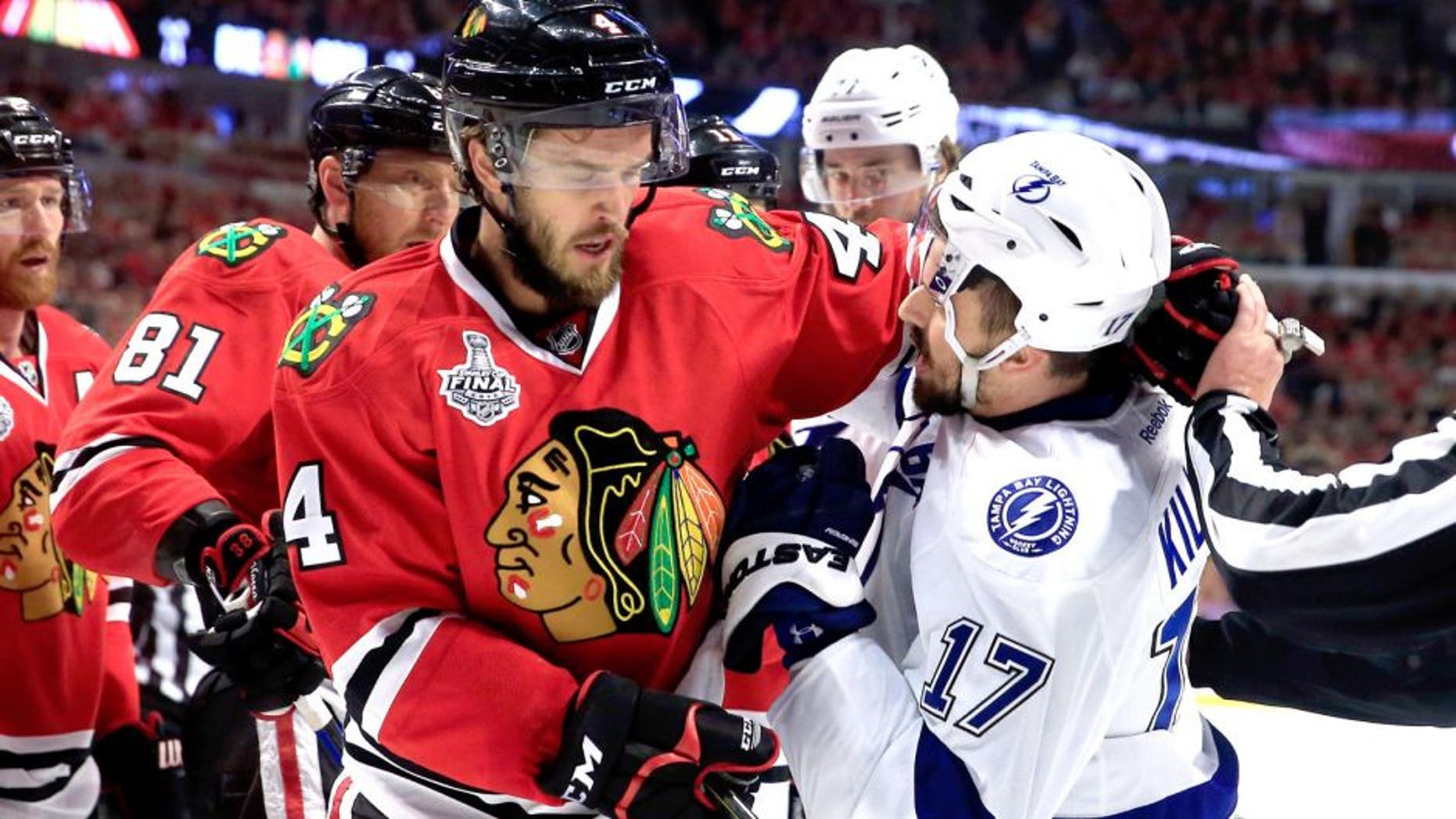 CHICAGO, IL - JUNE 10: Alex Killorn #17 of the Tampa Bay Lightning and Niklas Hjalmarsson #4 of the Chicago Blackhawks get involved after the whistle in the first period during Game Four of the 2015 NHL Stanley Cup Final at the United Center on June 10, 2015 in Chicago, Illinois. (Photo by Tasos Katopodis/Getty Images)