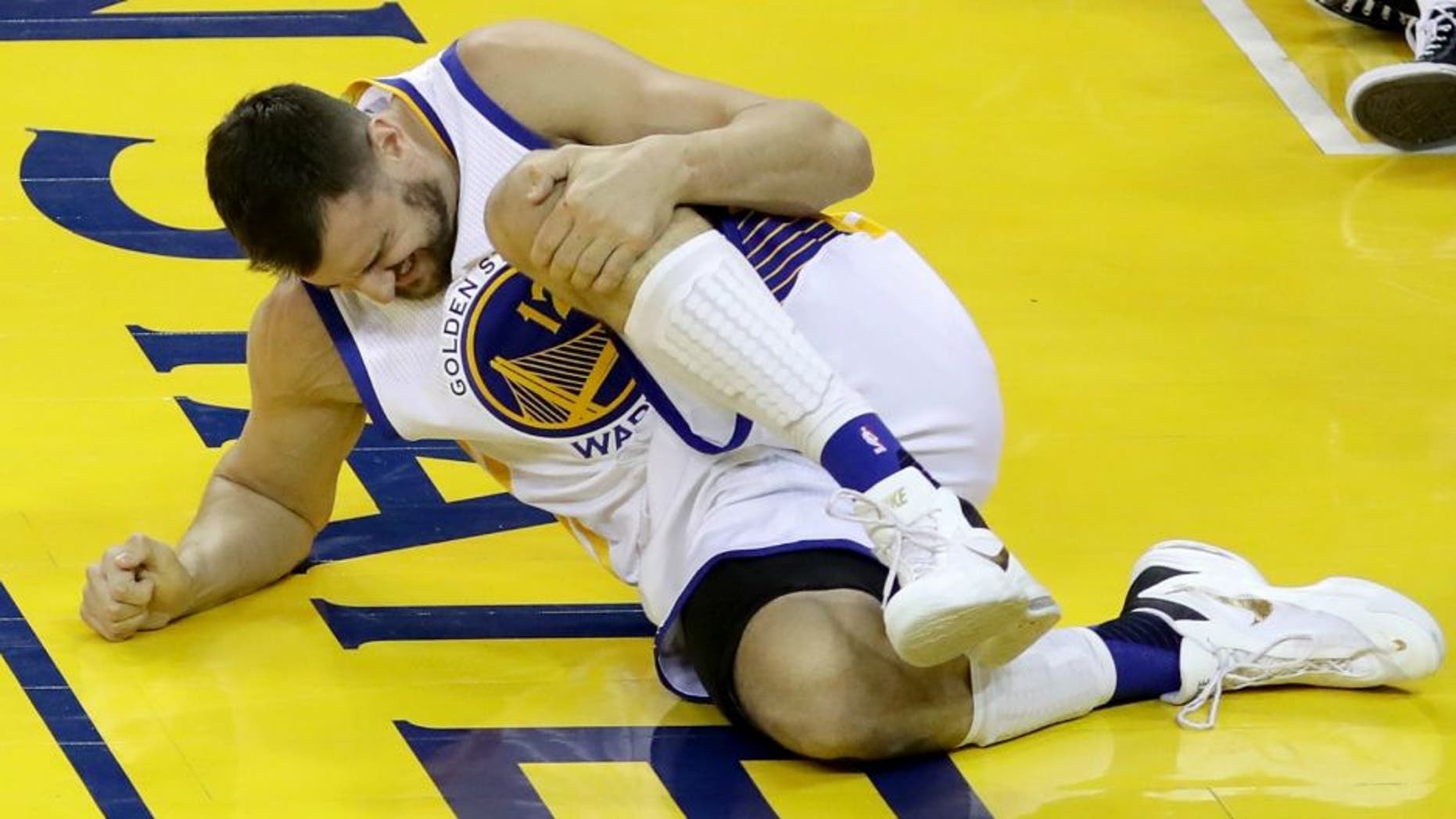 in Game 5 of the 2016 NBA Finals at ORACLE Arena on June 13, 2016 in Oakland, California. NOTE TO USER: User expressly acknowledges and agrees that, by downloading and or using this photograph, User is consenting to the terms and conditions of the Getty Images License Agreement.,OAKLAND, CA - JUNE 13: Andrew Bogut #12 of the Golden State Warriors holds his knee in pain after sustaining an injury during the third quarter against the Cleveland Cavaliers in Game 5 of the 2016 NBA Finals at ORACLE Arena on June 13, 2016 in Oakland, California. NOTE TO USER: User expressly acknowledges and agrees that, by downloading and or using this photograph, User is consenting to the terms and conditions of the Getty Images License Agreement. (Photo by Bruce Bennett/Getty Images)