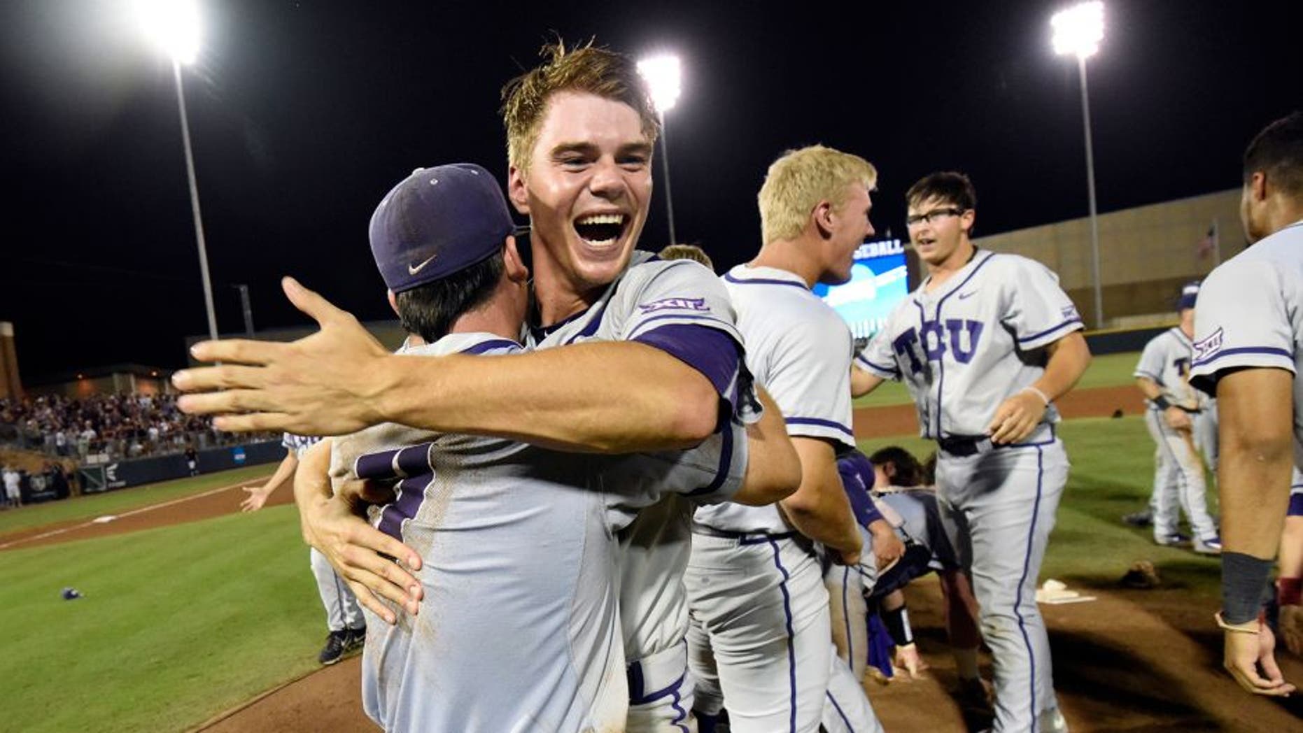 TCU's Connor Wanhanen, right, celebrates with teammate Josh Watson (7) after defeating Texas A&M 4-1 in a NCAA college baseball Super Regional tournament game, Sunday, June 12, 2016, in College Station, Texas. (AP Photo/Sam Craft)