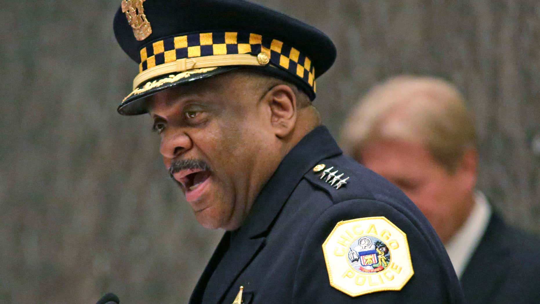 FILE - In this April 13, 2016, file photo, Eddie Johnson, left, speaks after being sworn in as the new Chicago police superintendent in Chicago.