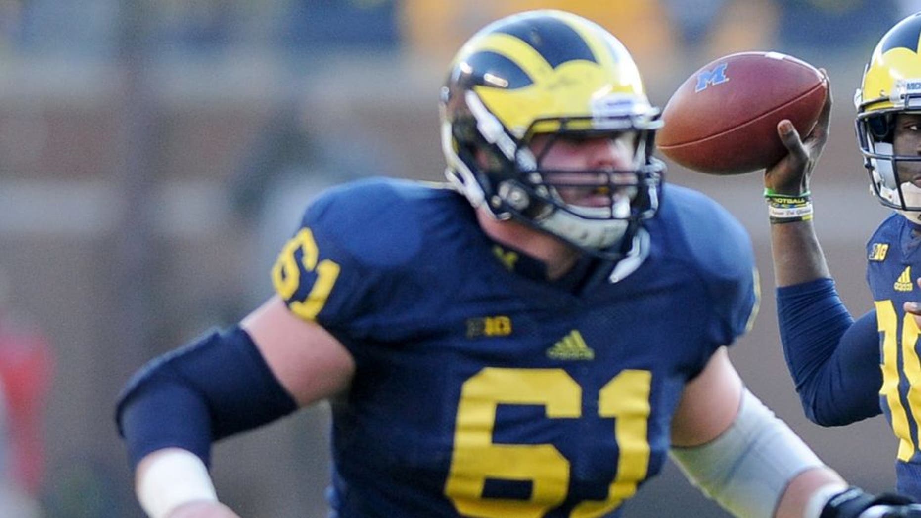 ANN ARBOR, MICHIGAN - NOVEMBER 30, 2013: Quarterback Devin Gardner #98 of the Michigan Wolverines throws a pass during a game against the Ohio State Buckeyes at Michigan Stadium in Ann Arbor, Michigan. The Buckeyes won 42-41. (Photo by David Dermer/Diamond Images/Getty Images)
