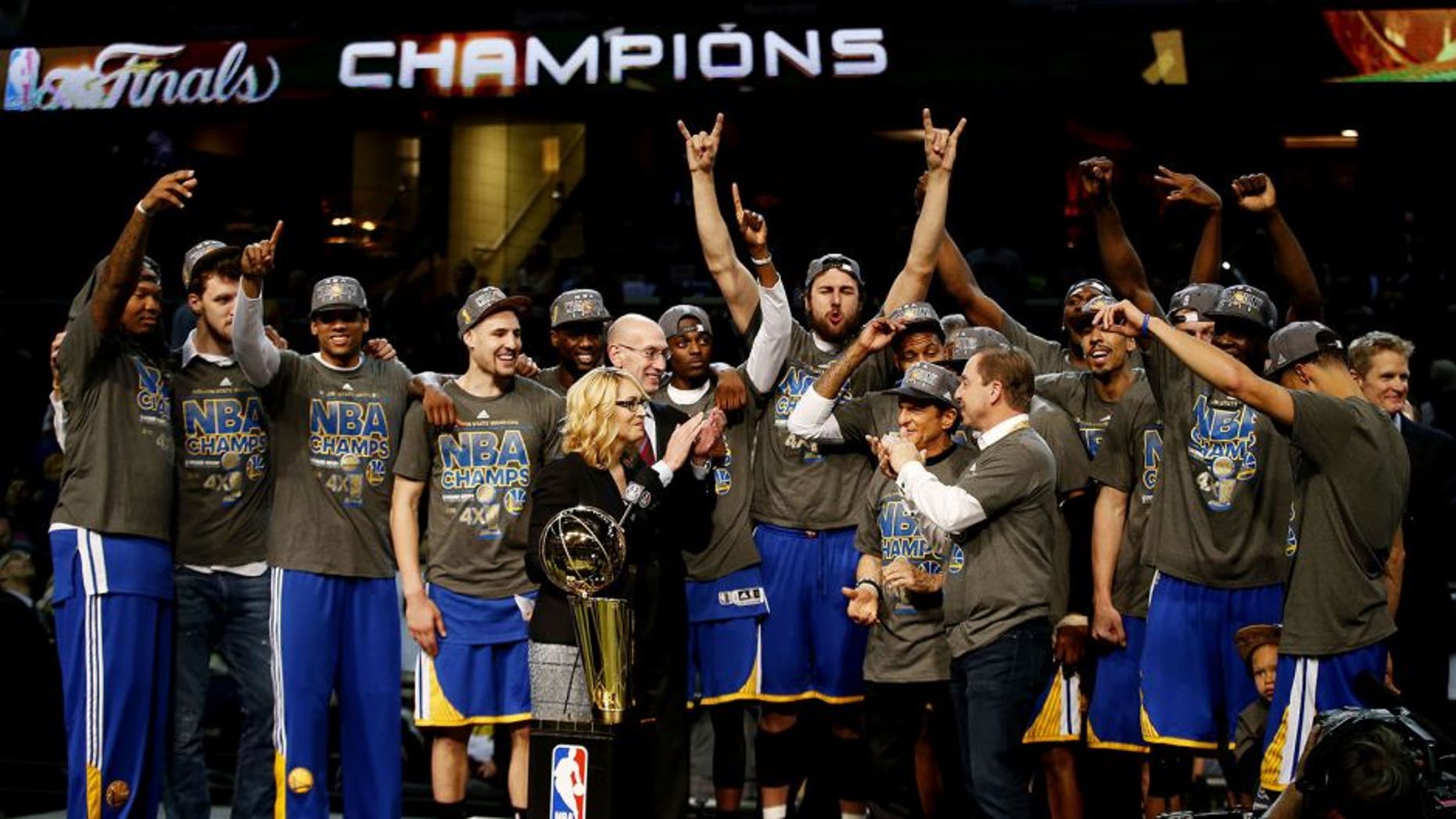 CLEVELAND, OH - JUNE 16: The Golden State Warriors celebrates with the Larry O'Brien NBA Championship Trophy after winning Game Six of the 2015 NBA Finals against the Cleveland Cavaliers at Quicken Loans Arena on June 16, 2015 in Cleveland, Ohio. NOTE TO USER: User expressly acknowledges and agrees that, by downloading and or using this photograph, user is consenting to the terms and conditions of Getty Images License Agreement. (Photo by Ezra Shaw/Getty Images)