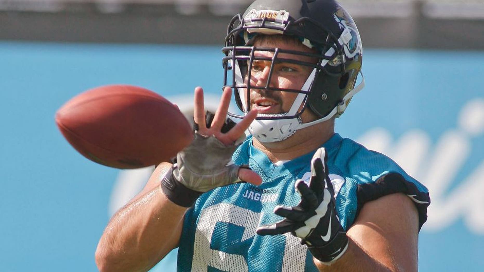 Jun 16, 2015; Jacksonville, FL, USA; Jacksonville Jaguars center Stefen Wisniewski (61) catches the ball during minicamp at the Florida Blue Health and Wellness Practice Fields. Mandatory Credit: Phil Sears-USA TODAY Sports