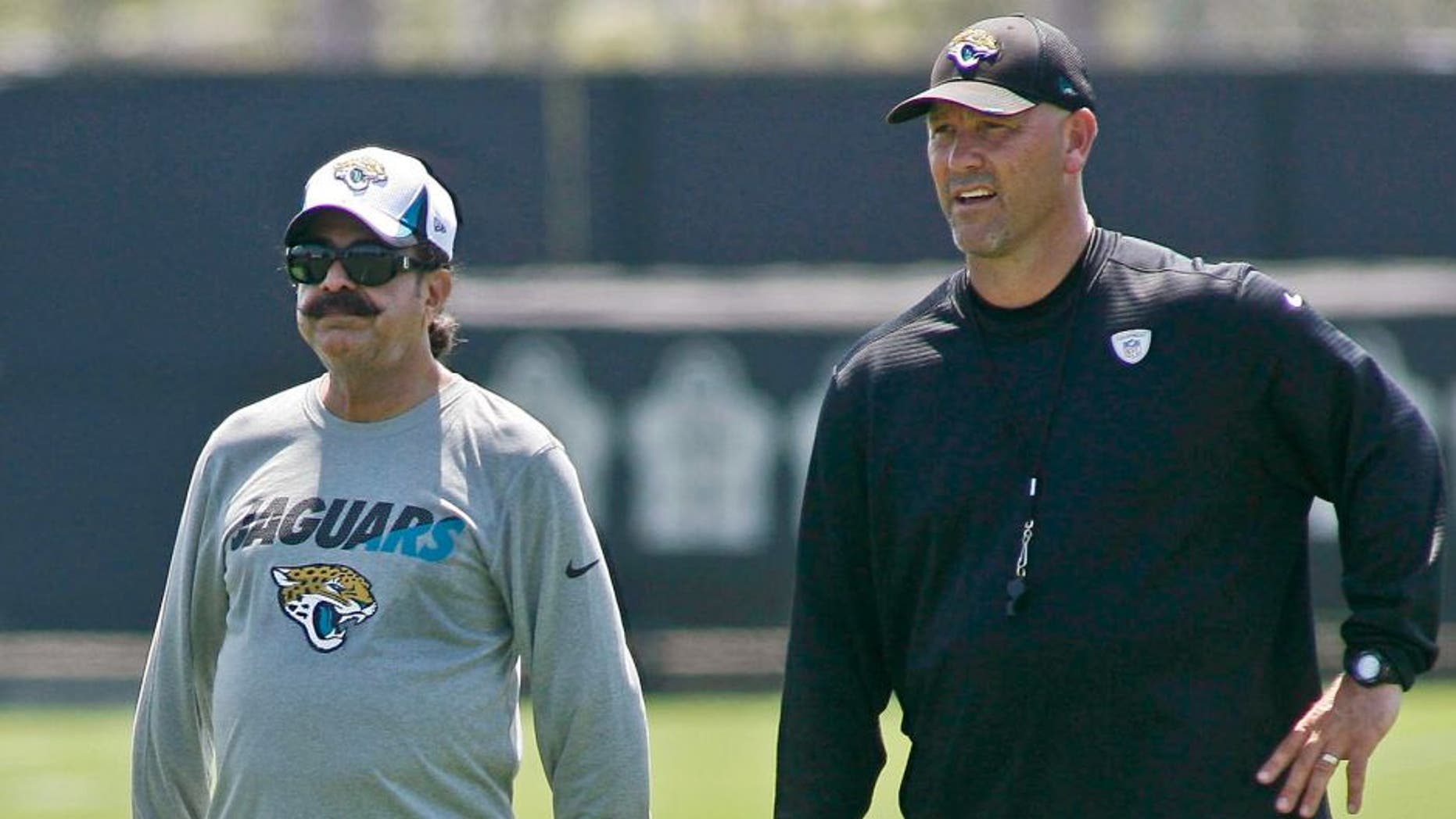 Jun 16, 2015; Jacksonville, FL, USA; Jacksonville Jaguars owner Shad Khan (left) and head coach Gus Bradley during minicamp at the Florida Blue Health and Wellness Practice Fields. Mandatory Credit: Phil Sears-USA TODAY Sports