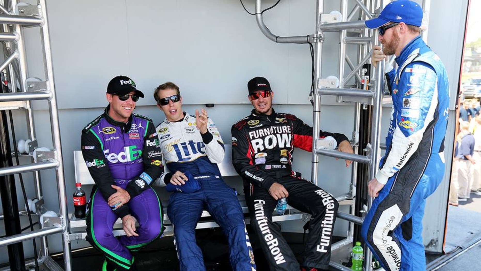 WATKINS GLEN, NY - AUGUST 09: (L-R) Denny Hamlin, driver of the #11 FedEx Ground Toyota, Brad Keselowski, driver of the #2 Miller Lite/Luke Bryan Ford, Martin Truex Jr., driver of the #78 Furniture Row/Visser Precision Chevrolet, and Dale Earnhardt Jr., driver of the #88 Nationwide Chevrolet, talk behind stage prior to the NASCAR Sprint Cup Series Cheez-It 355 at the Glen at Watkins Glen International on August 9, 2015 in Watkins Glen, New York. (Photo by Jerry Markland/Getty Images)