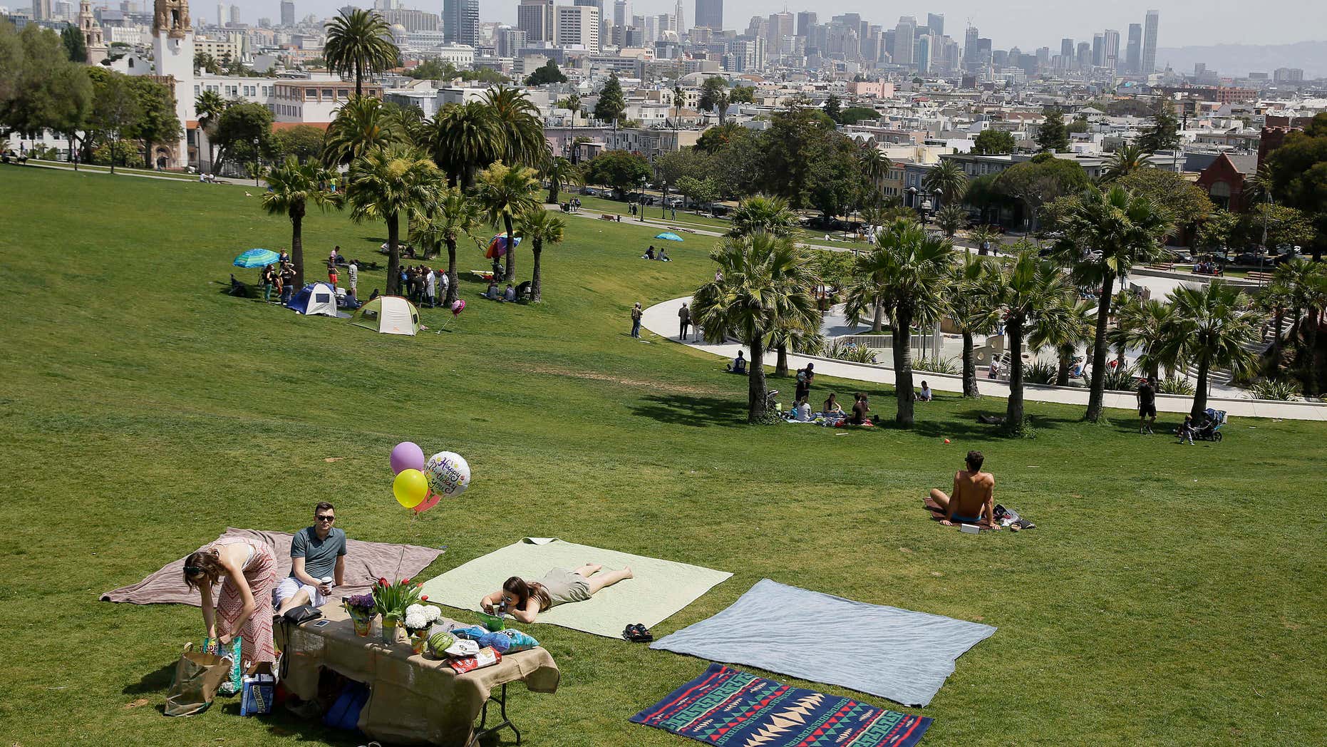 May 28, 2016: A group spreads out blankets for a party at Dolores Park in San Francisco.