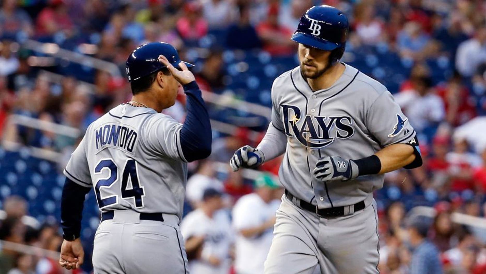 Tampa Bay Rays third base coach Charlie Montoyo (24) congratulates Steven Souza Jr. (20) as he rounds the bases on a solo home run during the fifth inning of a baseball game against the Washington Nationals at Nationals Park, Wednesday, June 17, 2015, in Washington. (AP Photo/Alex Brandon)