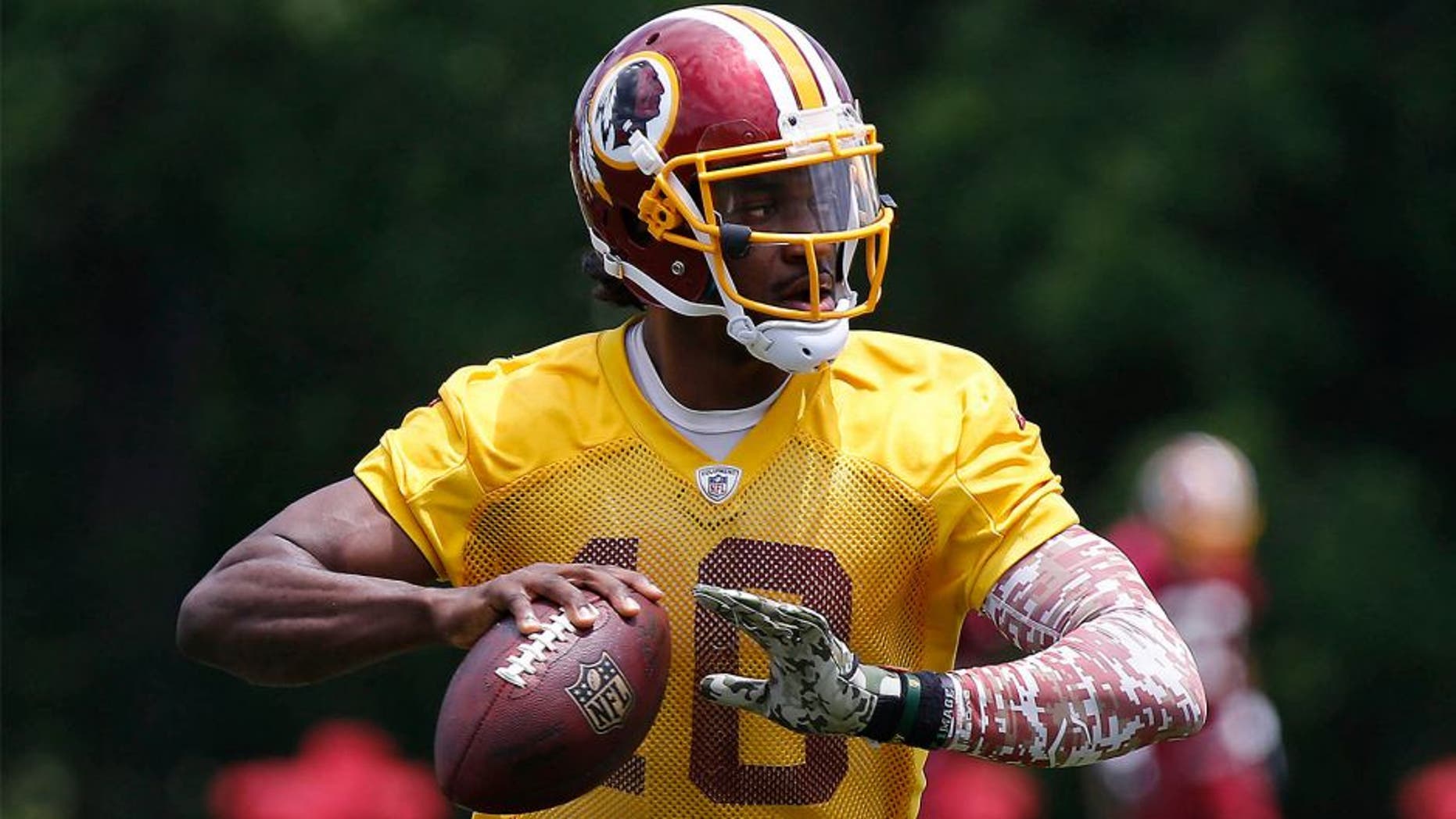 Jun 16, 2015; Ashburn, VA, USA; Washington Redskins quarterback Robert Griffin III (10) prepares to throw the ball during drills as part of day one of Redskins Minicamp at Redskins Park. Mandatory Credit: Geoff Burke-USA TODAY Sports