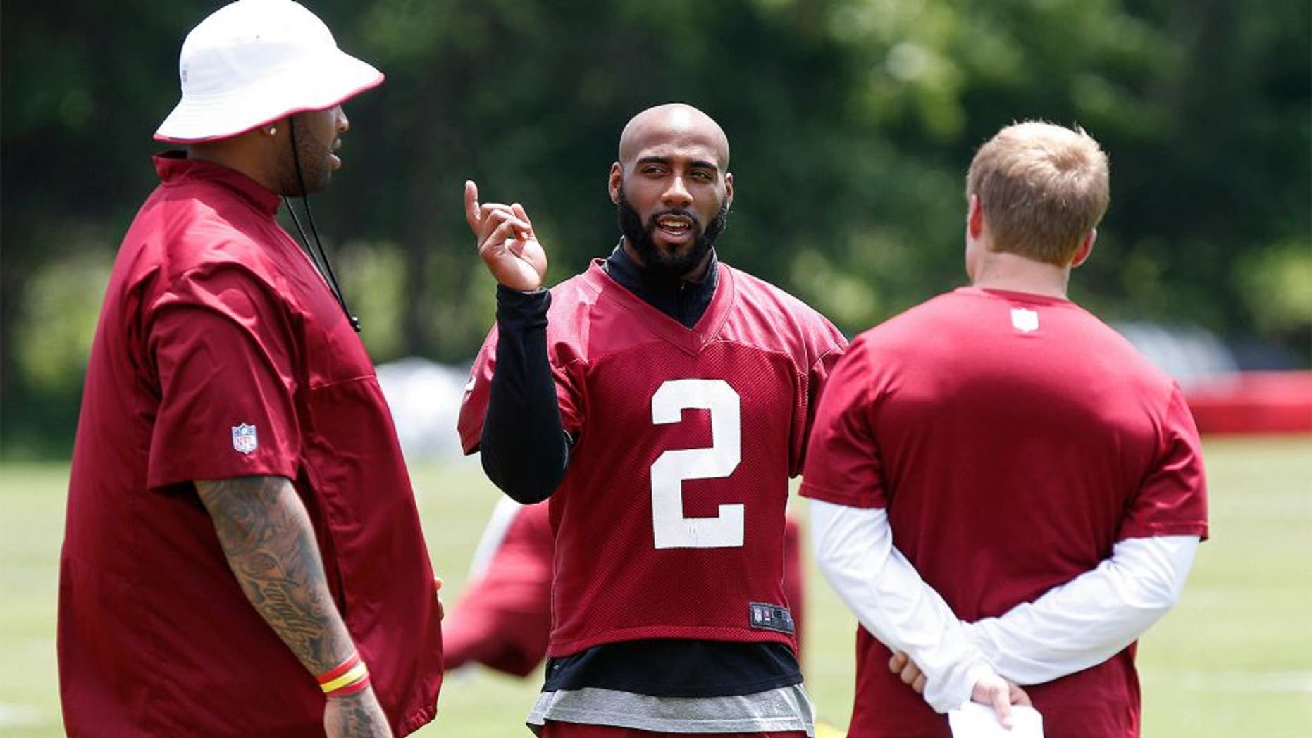 Jun 16, 2015; Ashburn, VA, USA; Washington Redskins cornerback DeAngelo Hall (2) talk with Redskins tackle Trent Williams (L) and Redskins offensive coordinator Sean McVay (R) on the sidelines during day one of Redskins Minicamp at Redskins Park. Mandatory Credit: Geoff Burke-USA TODAY Sports