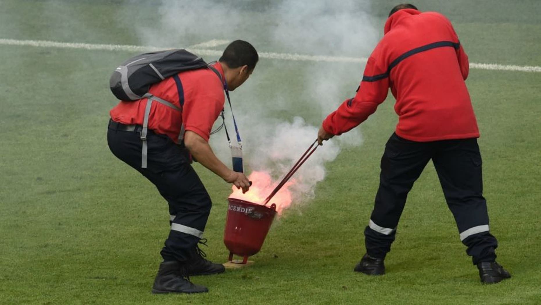 Croatia's midfielder Marcelo Brozovic reacts as firefighter extinguish a flare during the Euro 2016 group D football match between Czech Republic and Croatia at the Geoffroy-Guichard stadium in Saint-Etienne on June 17, 2016. Czech Republic and Croatia drew 2-2. / AFP / JEAN-PHILIPPE KSIAZEK (Photo credit should read JEAN-PHILIPPE KSIAZEK/AFP/Getty Images)