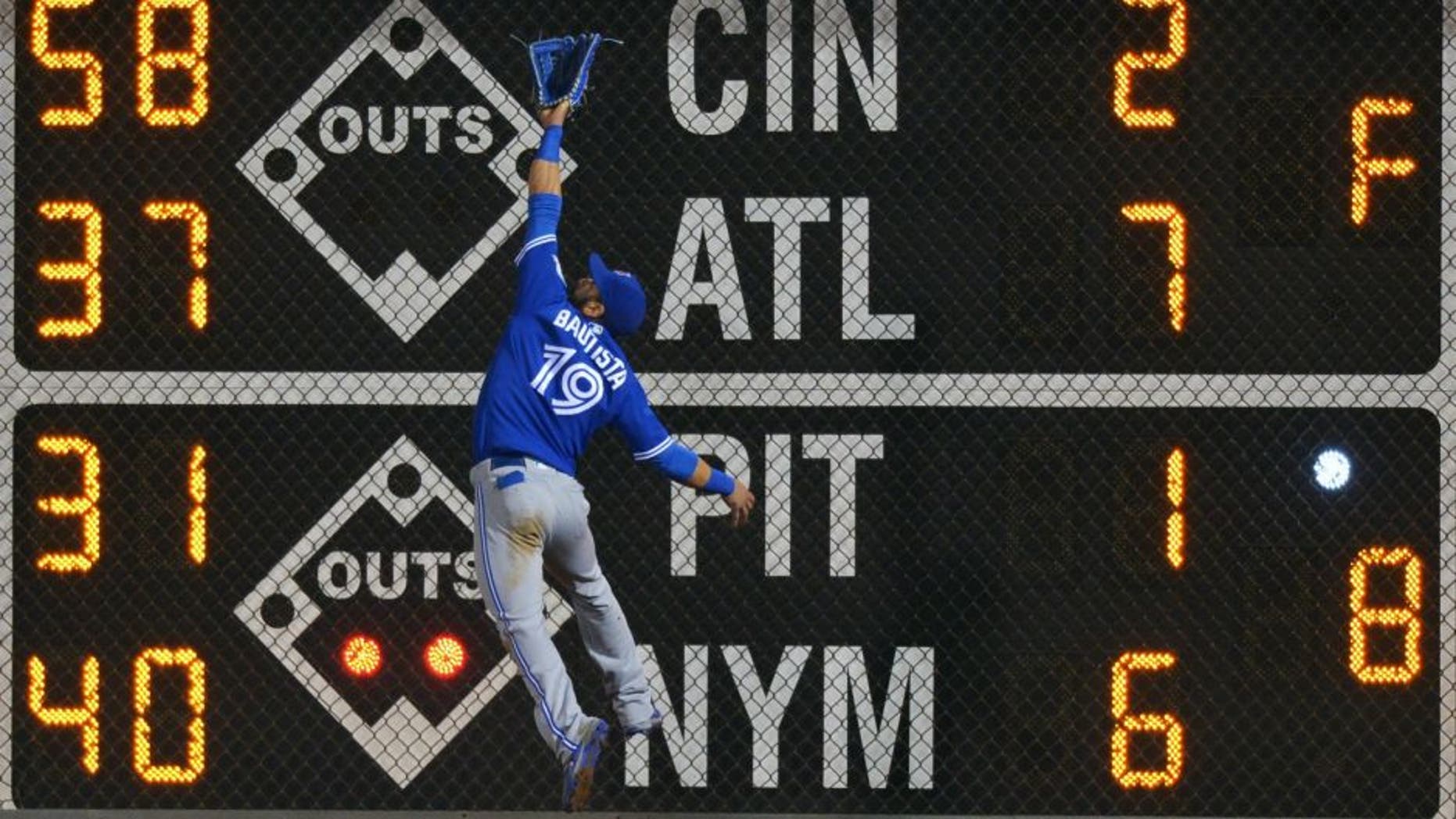 PHILADELPHIA, PA - JUNE 16: Jose Bautista #19 of the Toronto Blue Jays jumps for a fly ball but is unable to make the catch in the seventh inning against the Philadelphia Phillies at Citizens Bank Park on June 16, 2016 in Philadelphia, Pennsylvania. Bautista was injured on the play. (Photo by Drew Hallowell/Getty Images)