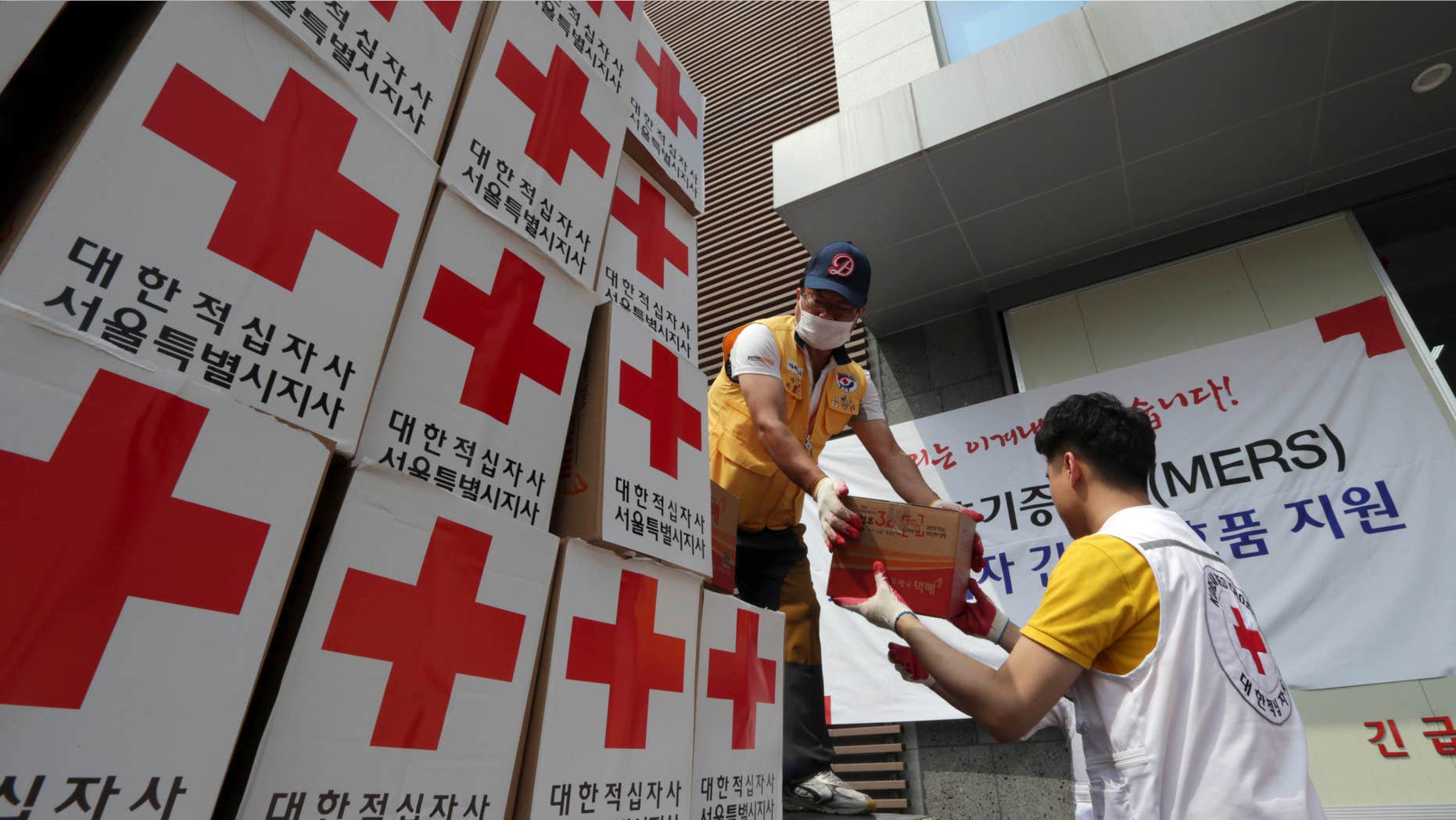 June 18, 2015: Members of South Korean Red Cross unload relief items from a truck for people who are suspected of infection and isolated at their home after having close contact with MERS patients, at Red Cross Emergency Relief Operation Center in Seoul, South Korea.