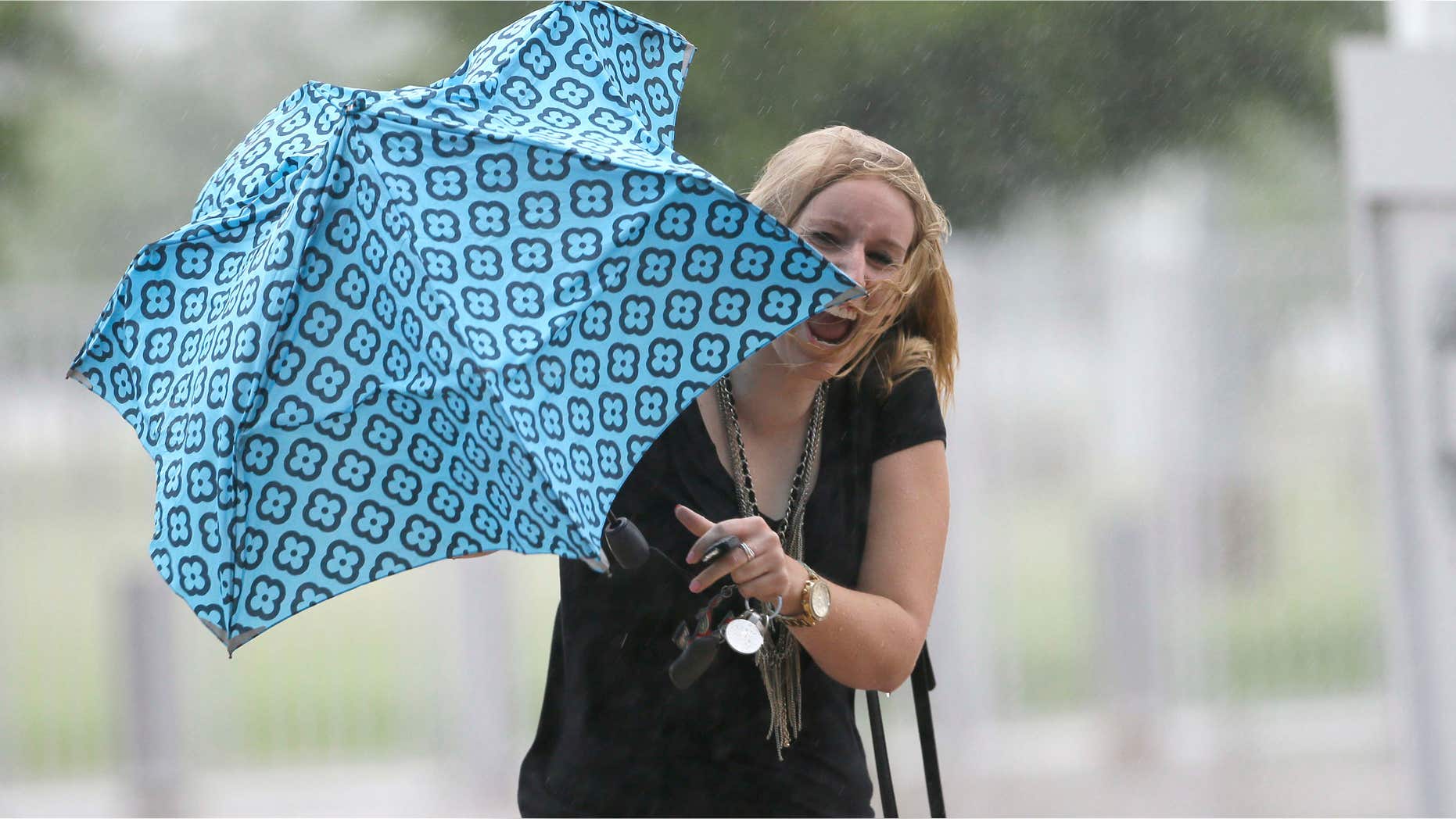June 17, 2015: Betsy Lauritzen reacts after she was caught off guard by a strong gust of wind caused by Tropical Depression Bill in Arlington, Texas.