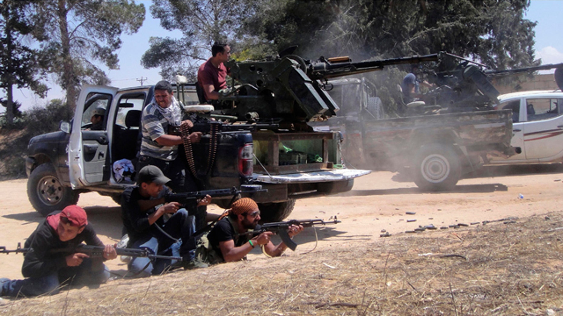 June 17: Rebel fighters fire their machine gun towards pro-Qaddafi forces on the front line of Dafniya in Misrata, Libya.