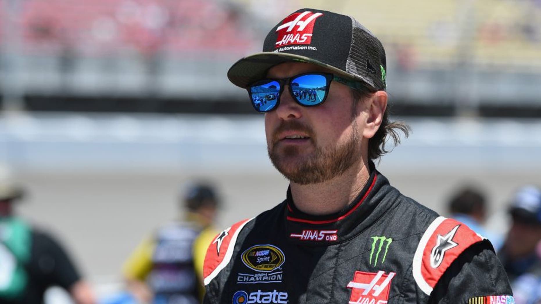 BROOKLYN, MI - JUNE 12: Kurt Busch, driver of the #41 Haas Automation/Monster Energy Chevrolet, stands on the grid prior to the NASCAR Sprint Cup Series FireKeepers Casino 400 at Michigan International Speedway on June 12, 2016 in Brooklyn, Michigan. (Photo by Josh Hedges/Getty Images )