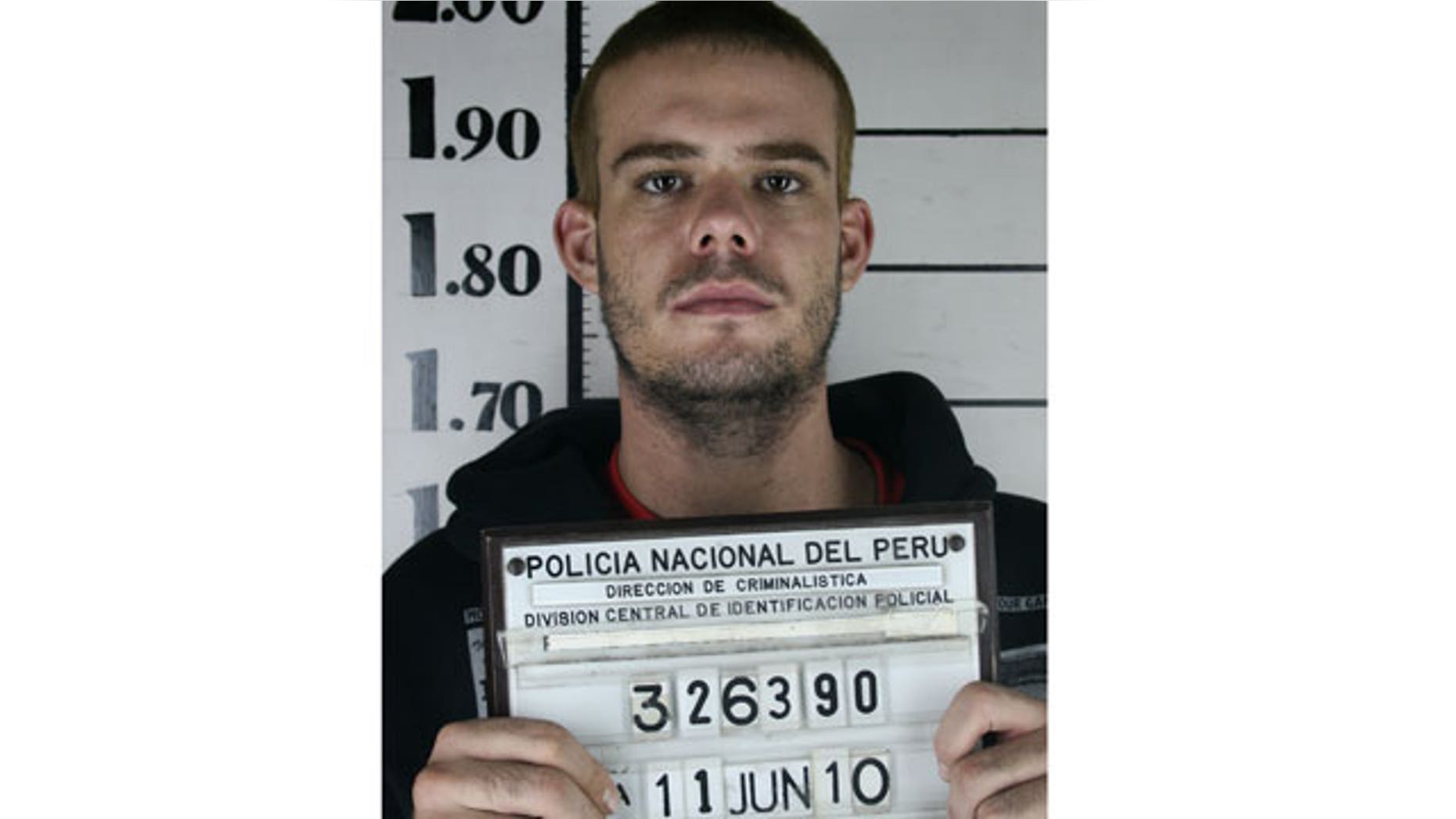 June 11: Dutch citizen Joran van der Sloot holds his inmate number before been transferred to the Miguel Castro Castro prison in Lima.