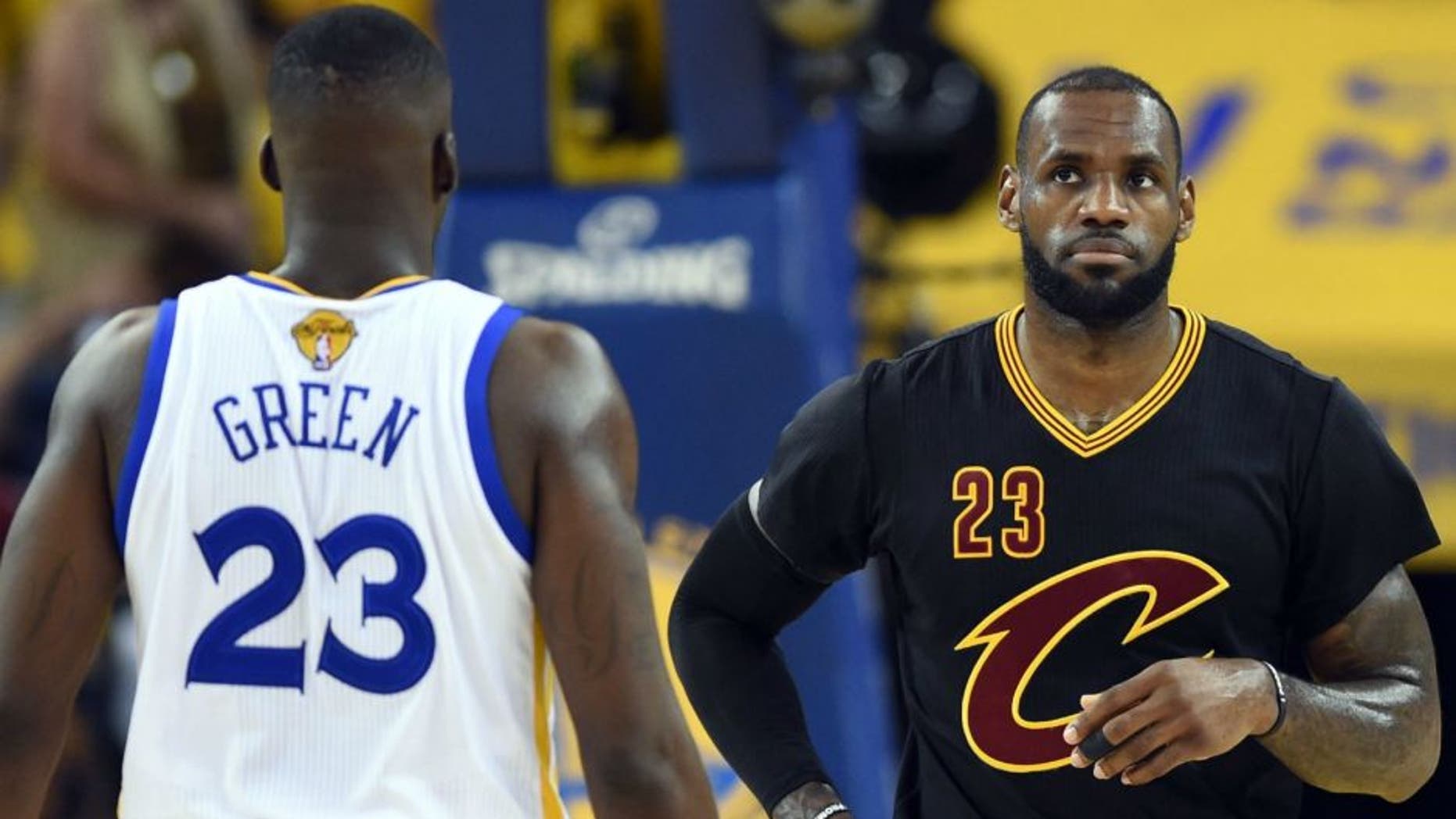 Jun 19, 2016; Oakland, CA, USA; Cleveland Cavaliers forward LeBron James (23) and Golden State Warriors forward Draymond Green (23) during the first quarter in game seven of the NBA Finals at Oracle Arena. Mandatory Credit: Bob Donnan-USA TODAY Sports