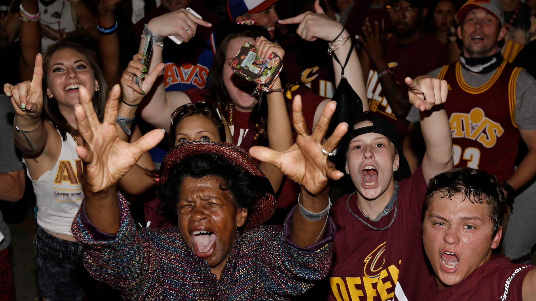 Cleveland Cavaliers fans celebrate after the Cavaliers defeated the Golden State Warriors 93-89 in Game 7 of the NBA basketball Finals, Sunday, June 19, 2016, in Cleveland.