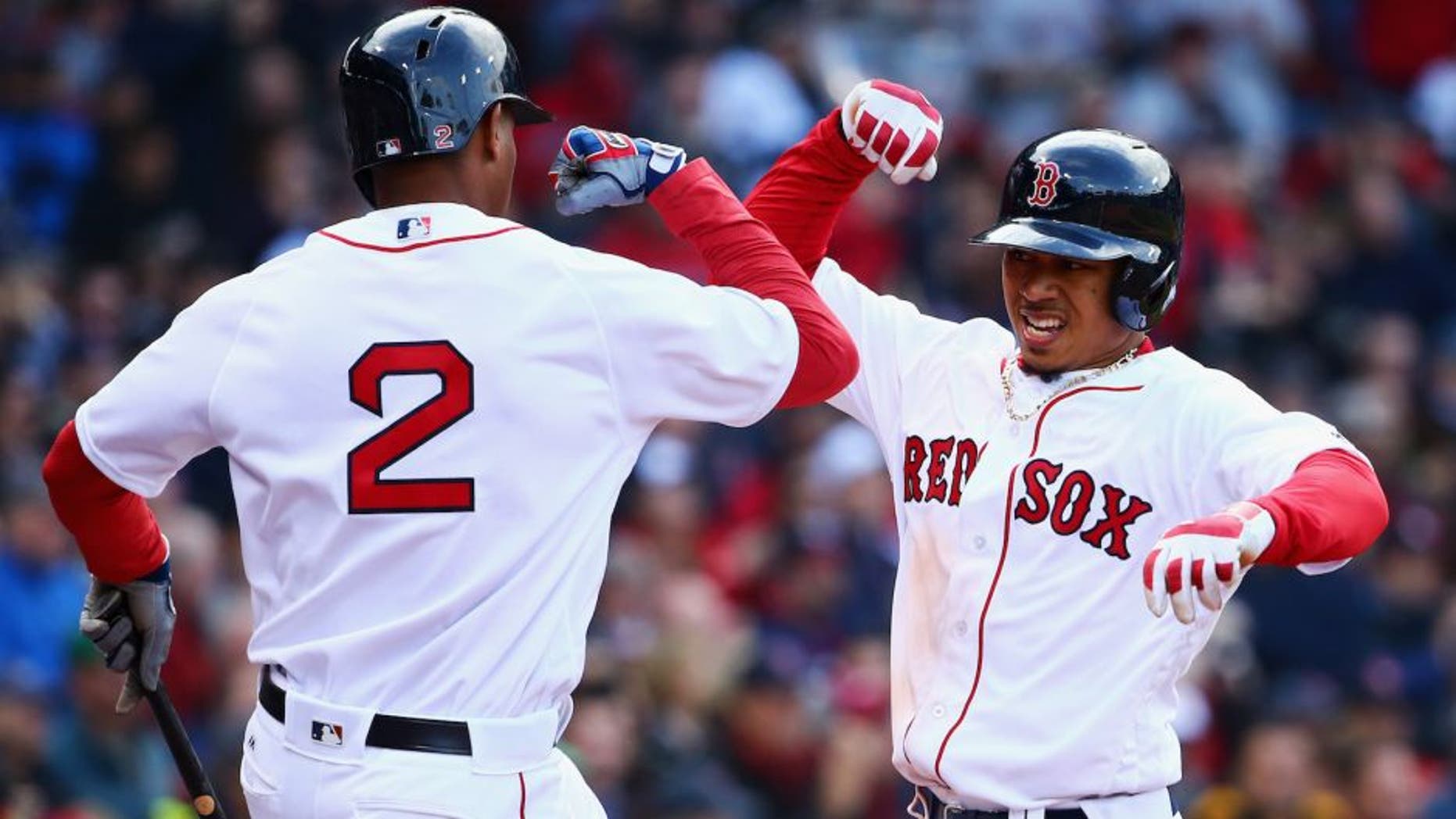 BOSTON, MASSACHUSETTS - APRIL 11: Mookie Betts #50 of the Boston Red Sox celebrates with Xander Bogaerts #2 of the Boston Red Sox after hitting a home run during the ninth inning of the Red Sox home opener at Fenway Park on April 11, 2016 in Boston, Massachusetts. The Orioles defeat the Red Sox 9-7. (Photo by Maddie Meyer/Getty Images)