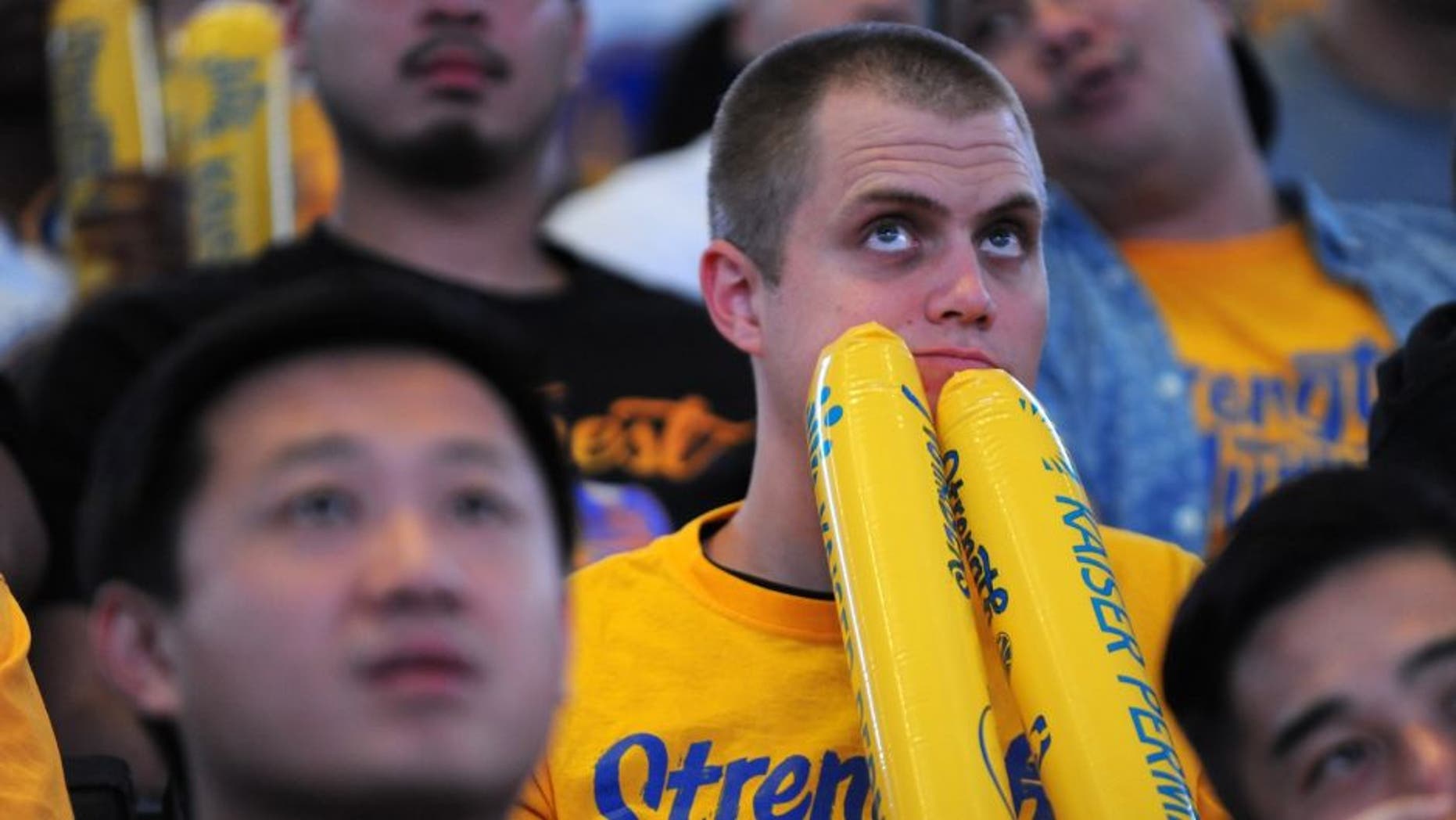 OAKLAND, CA - JUNE 16: A fan reacts in the final moments of Game Six during the Golden State Warriors NBA Finals watch party at ORACLE Arena on June 16, 2016 in Oakland, California. (Photo by Robert Reiners/Getty Images)