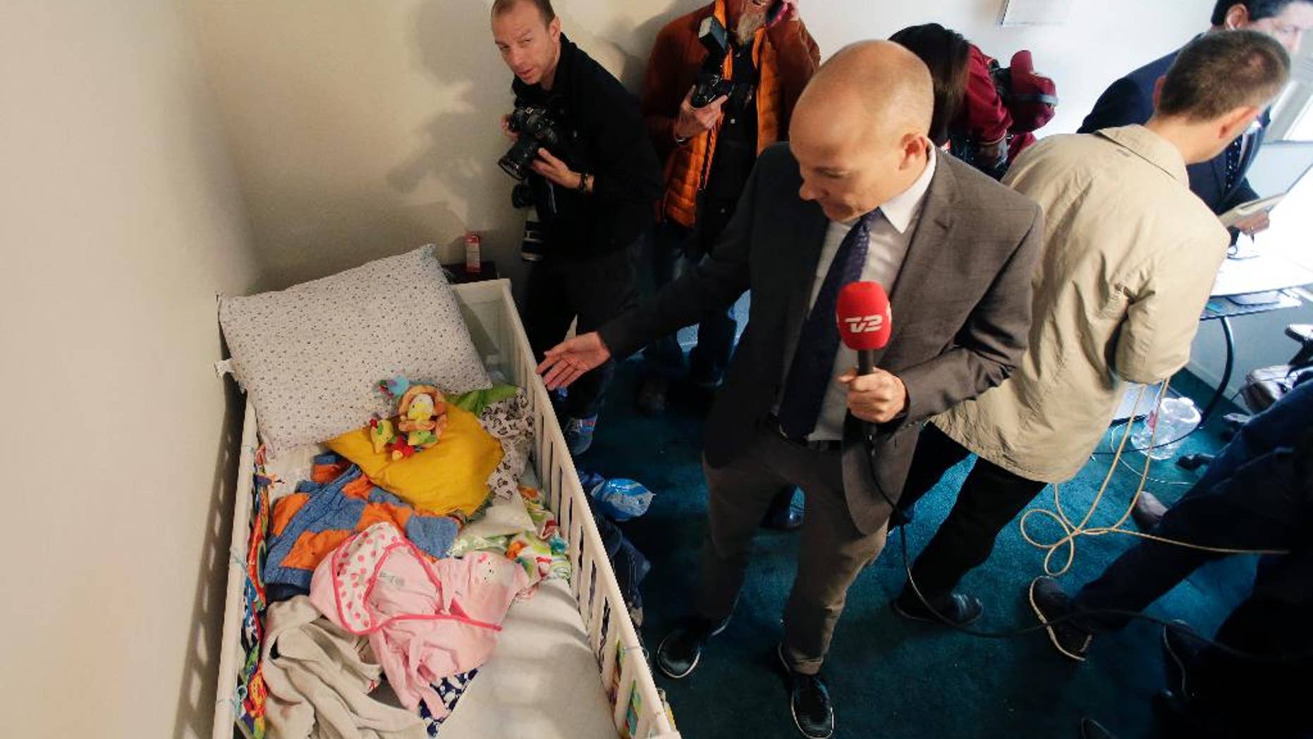 Members of the media crowd into a child's room in an apartment in Redlands, Calif., shared by San Bernardino shooting rampage suspects Syed Farook and his wife, Tashfeen Malik, Friday, Dec. 4, 2015, after the building landlord invited media into the townhouse rented by the California attackers. (AP Photo/Chris Carlson)