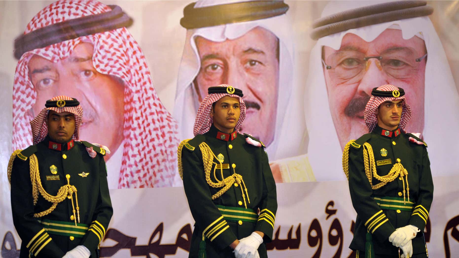 Feb. 18, 2014: Saudi royal guards stand on duty in front of portraits of King Abdullah bin Abdulaziz, right, then Crown Prince Salman bin Abdulaziz, center, and Muqrin bin Abdulaziz during a culture festival in Riyadh, Saudi Arabia.